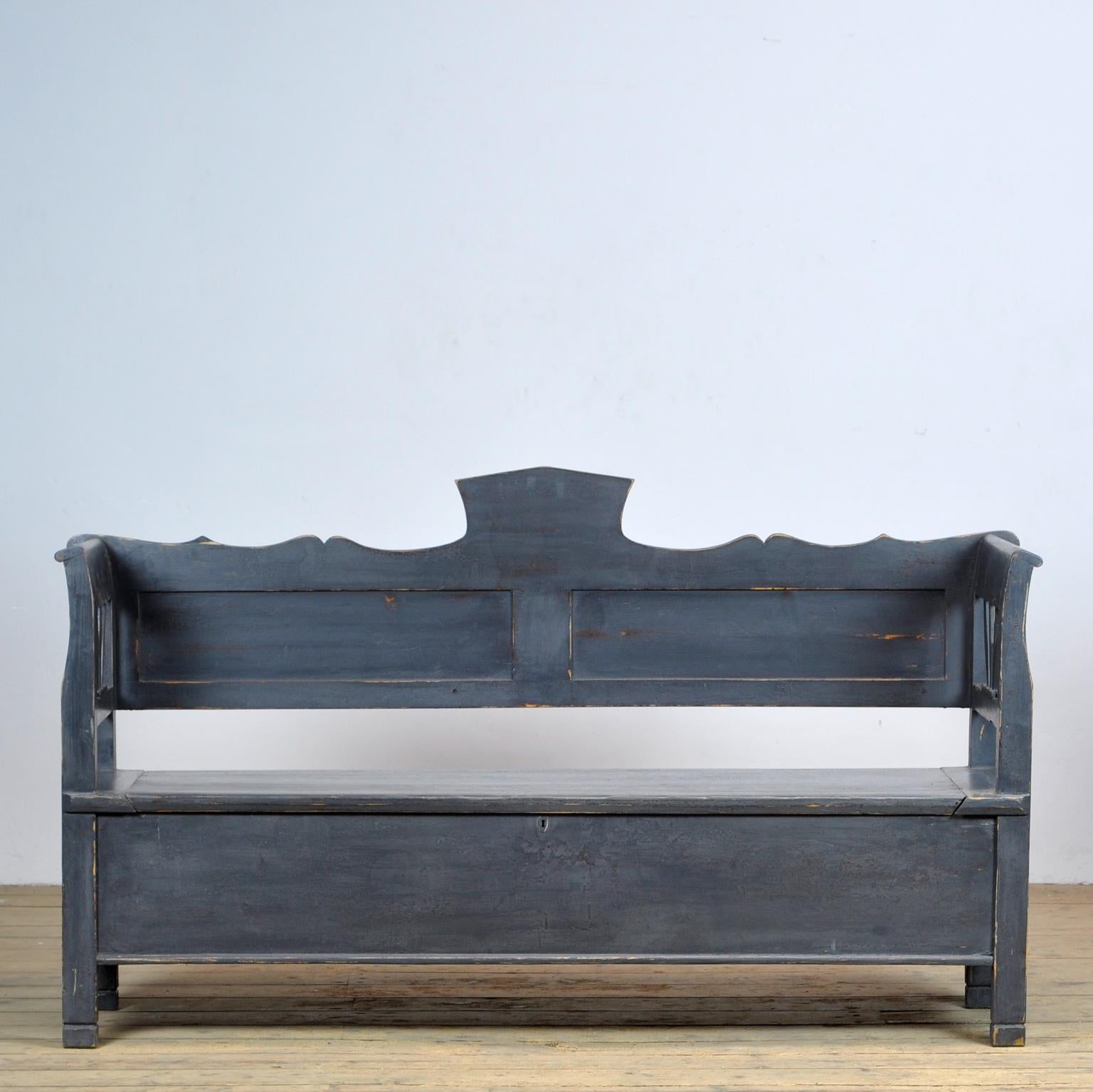A charming bench from Hungary with the original paint. Over time and use, the blue paint has been worn away in places to the wood. With storage space under the seat divided in two compartments. The bench is stable and sturdy. Free of woodworm. 