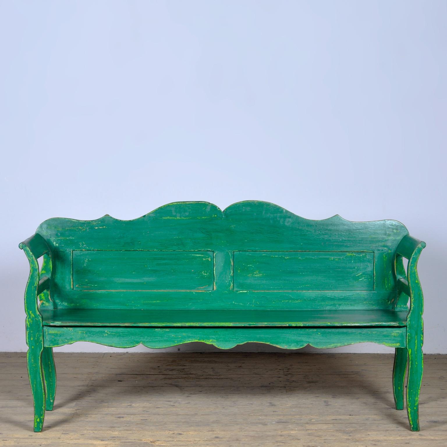 A charming bench from hungary with the original paint. Over time and use, the green paint has been worn away in places to the wood. The bench is stable and sturdy. Free of woodworm. 