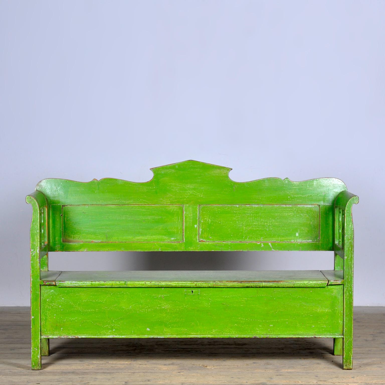 A charming bench from hungary with the original paint. Over time and use, the green paint has been worn away in places to the wood. With storage space under the seat divided in two compartments. The bench is stable and sturdy. Free of woodworm.