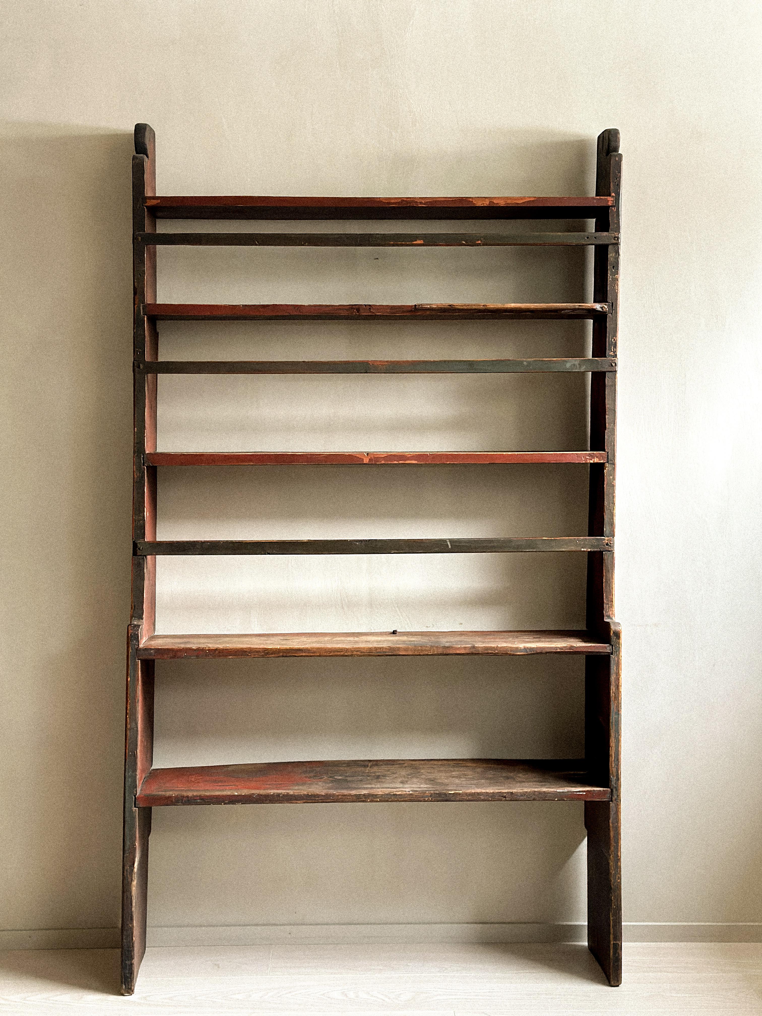 Beautiful antique book shelf in pine. Handcrafted by a Norwegian cabinetmaker in the mid 1800s.

A great vintage book shelf with a lovely patina. Should be attached to a wall to ensure stability. 

A unique rustic piece that fit in the wabi sabi