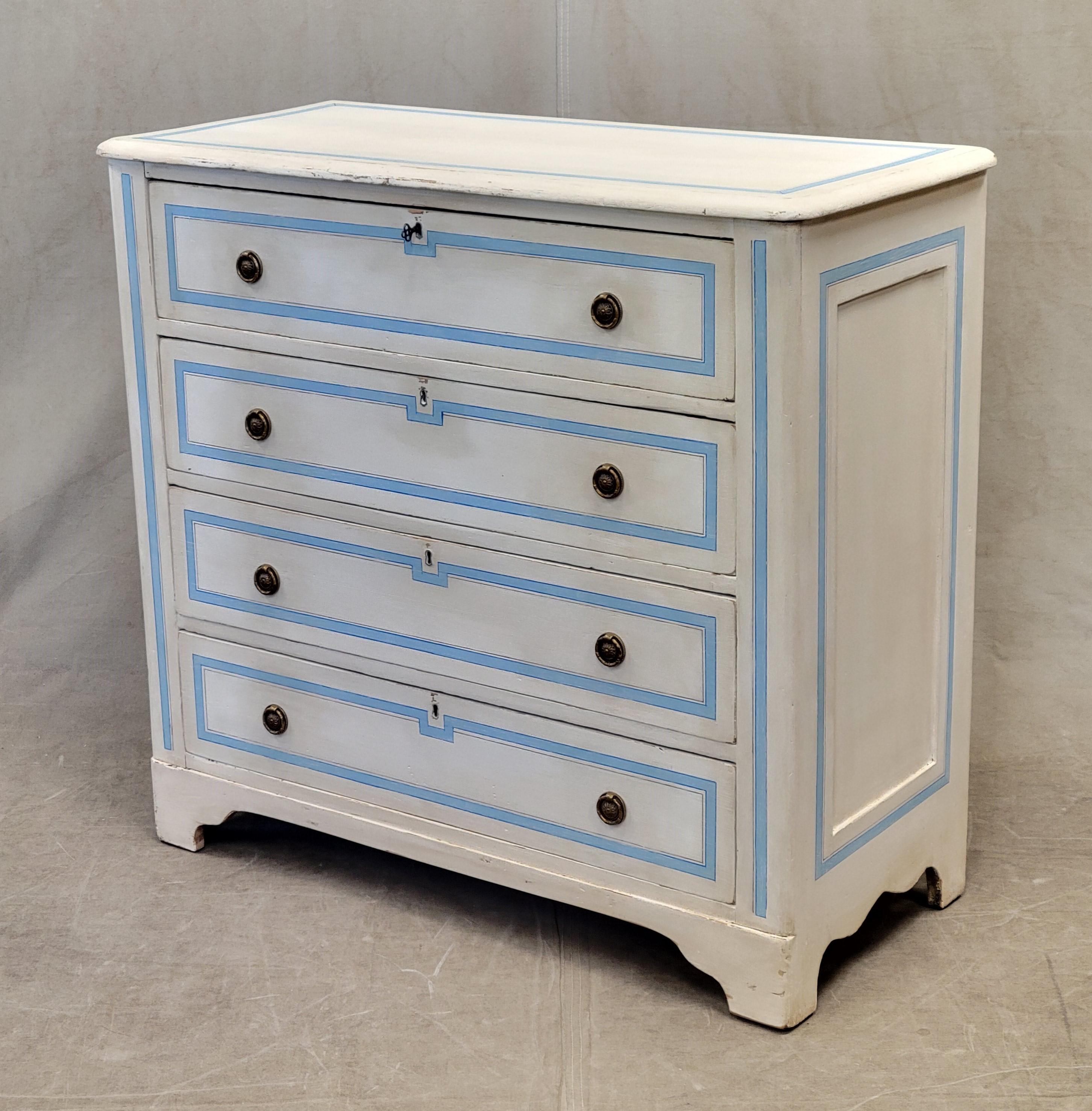An elegant and functional antique pine dresser with bracket feet, painted white and accented in a blue French line motif. Brass pull rings add to the elegance of this piece. The key works in top and third drawer.
Antique pine dresser is stable and