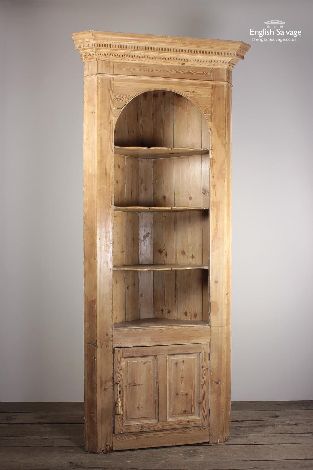Elegant, tall antique pine corner dresser / cupboard with three fitted fluted shelves, the top one of which is arched as well as a cupboard beneath with a further shelf and its own makeshift door pull (a curtain tassle)!! 

Some natural splitting