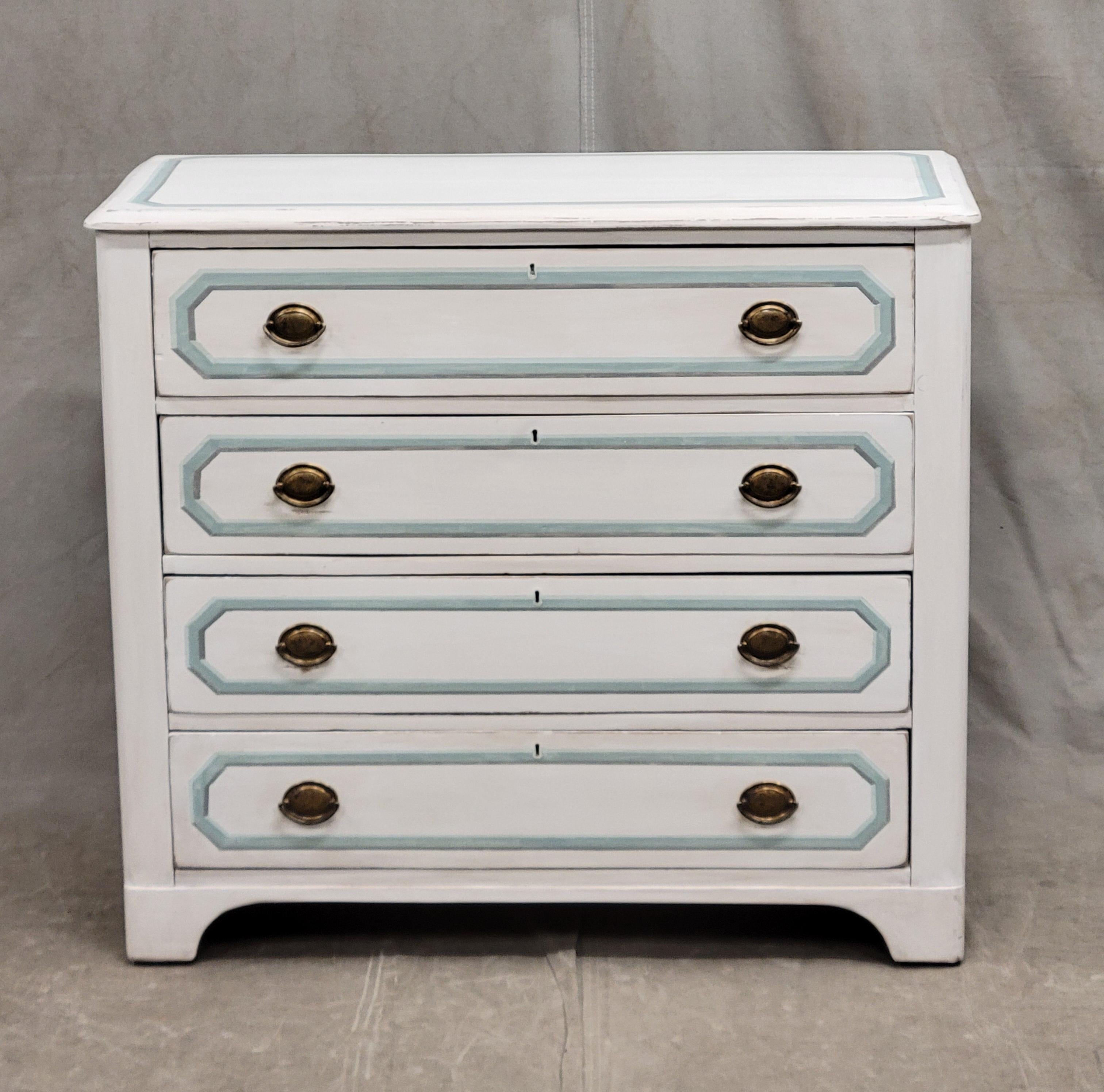 An elegant and functional antique pine dresser with bracket feet, painted white and accented in an aqua blue and gray French line motif. Note the distressed areas in the paint. Brass pull rings add to the elegance of this piece. Strong and sturdy,