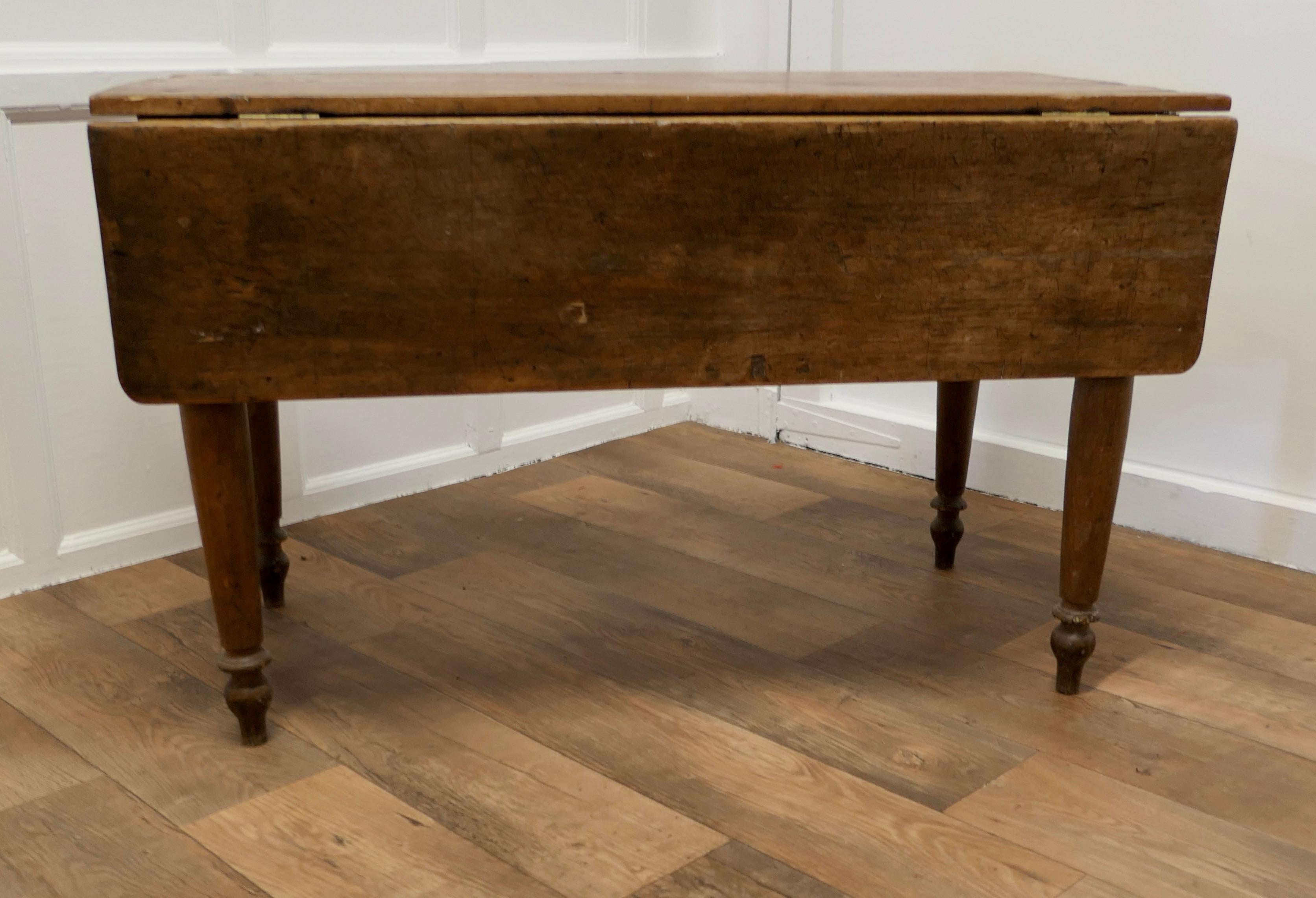 Antique Pine Drop Leaf Cottage Dining Table

This type of table is often know as a cottage diner because it is space saving with the leaves down and opens to a good size dining table when needed 

The table has a solid age darkened pine finish