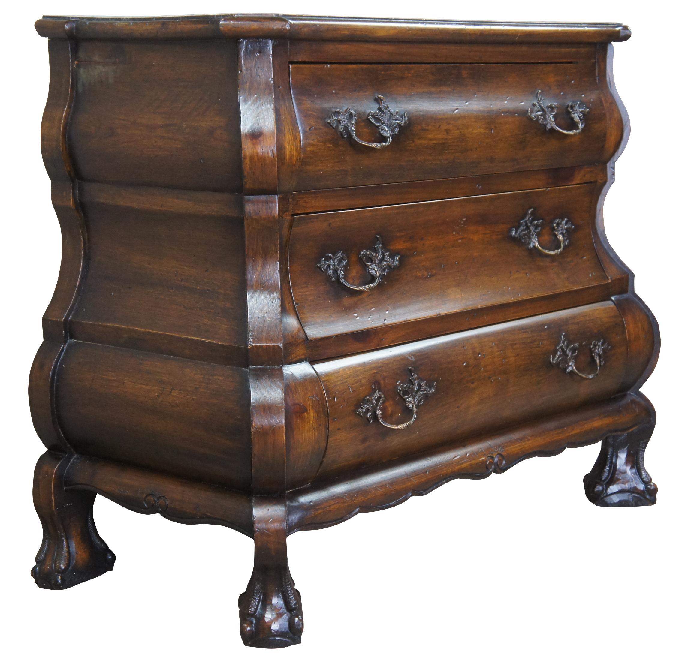 Early 20th century Dutch Bombe. Influenced by 18th century Dutch and Chippendale styling. Features a serpentine design made from pine with 3 drawers, ornate brass hardware and ball and claw feet. Great for an entry or foyer. Tag along the back torn;