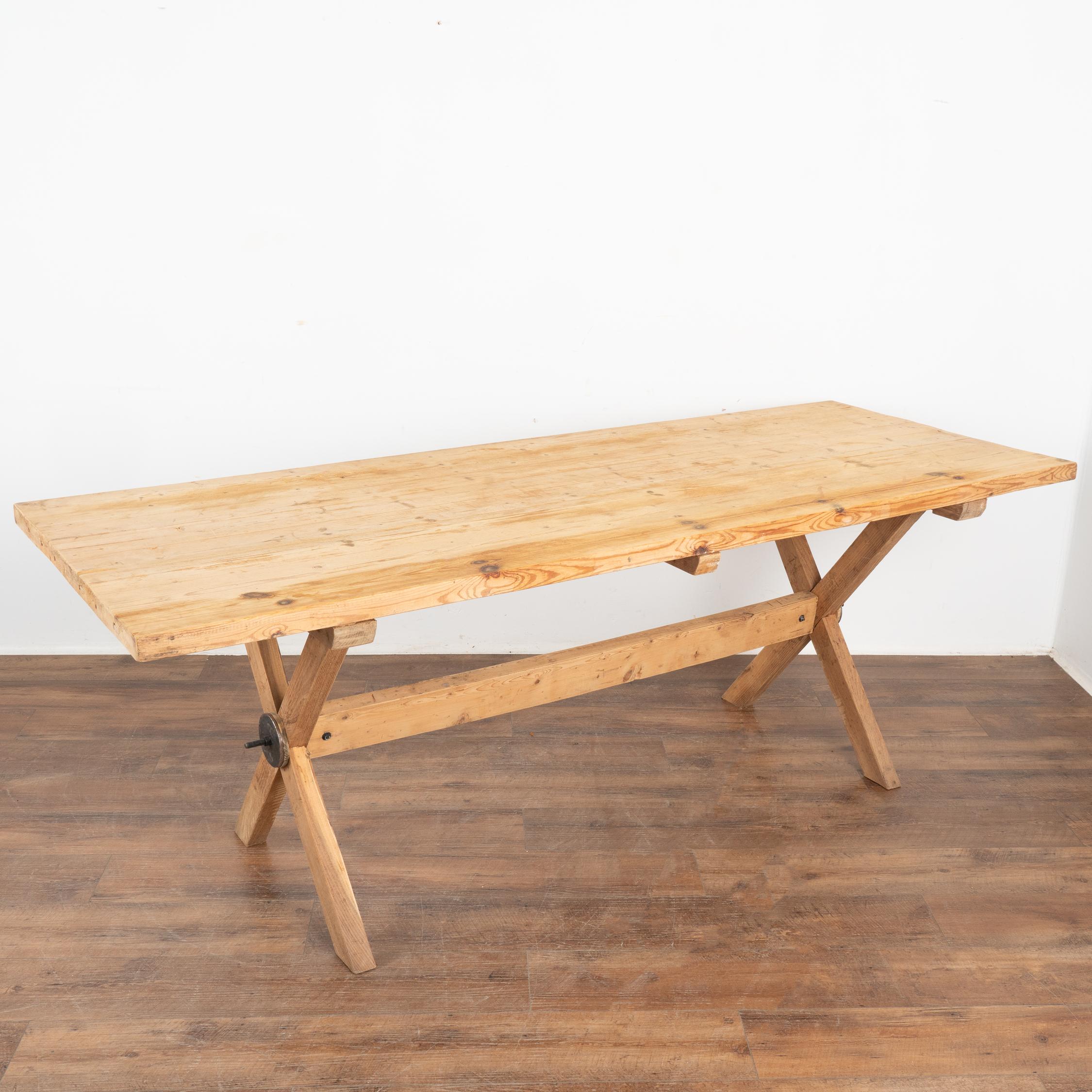 This 7' farmhouse dining or kitchen table has European country charm thanks to the unique X-stretcher base.
The natural pine has been distressed through generations of use, adding depth to the character of the table. The many scratches, dings,