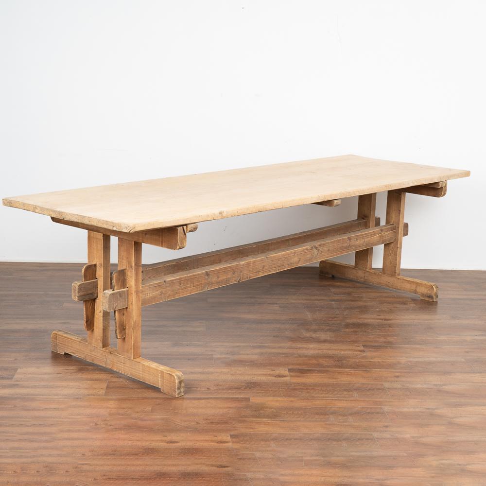 At almost 9' long, this wonderful old farm table from the Swedish countryside is a great find due to the much sought after length. The natural pine top is contrasted by a slightly darker hard wood trestle base. 
There is a 12