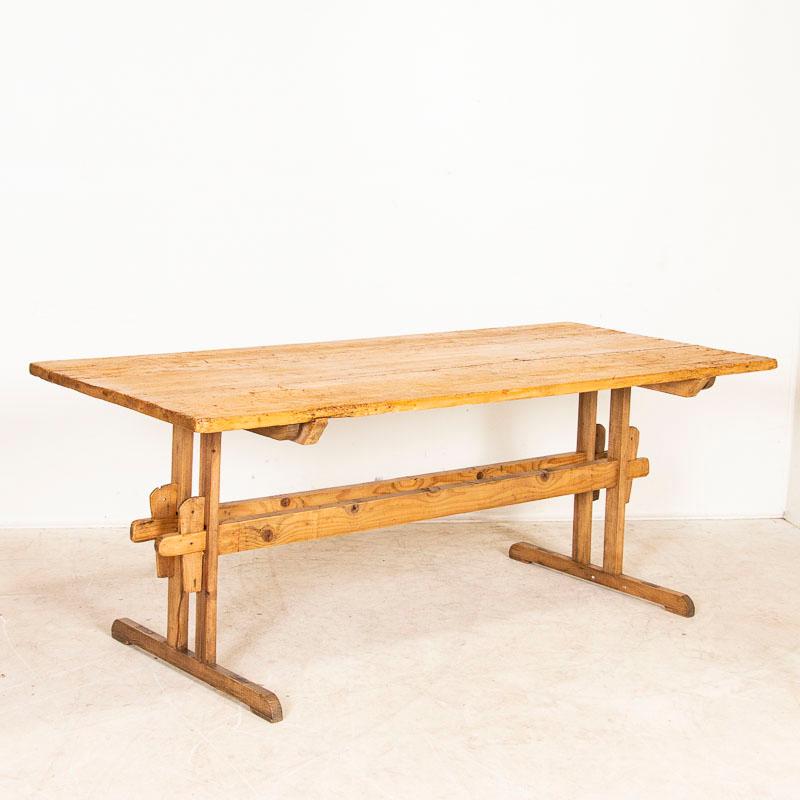 At just over 6' long, this old farmhouse table will serve well in today's modern home. The top of this table was made from 3 long planks, which reveal generations of use in every scratch, ding, gouge, and even old dried out worm holes (of no concern