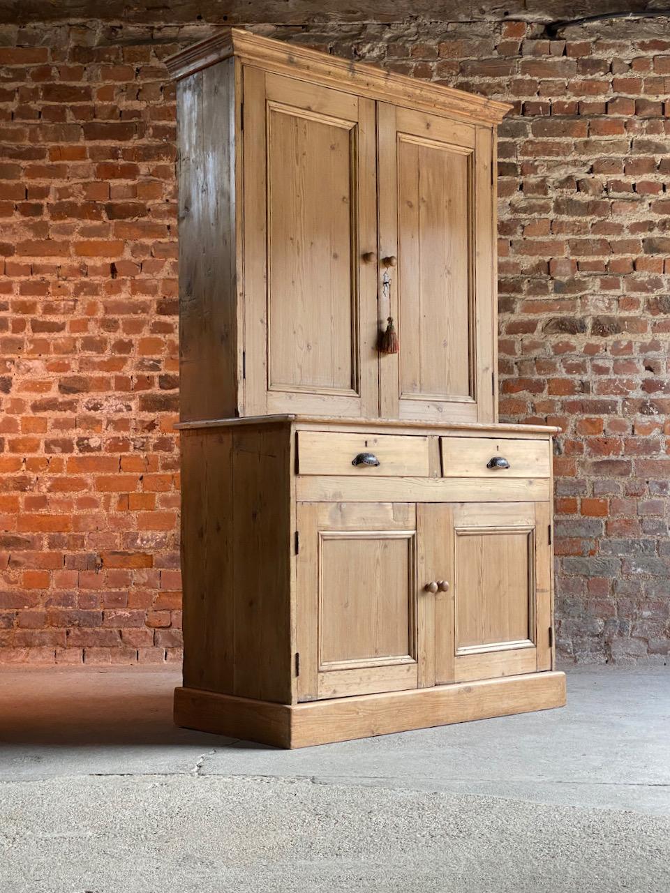 Antique pine housekeepers cupboard 19th Century Victorian. Circa 1890

Fabulous large antique Victorian pine housekeepers cupboard wardrobe 19th century circa 1890, the corniced top above two panelled doors with working lock and key, three shelves
