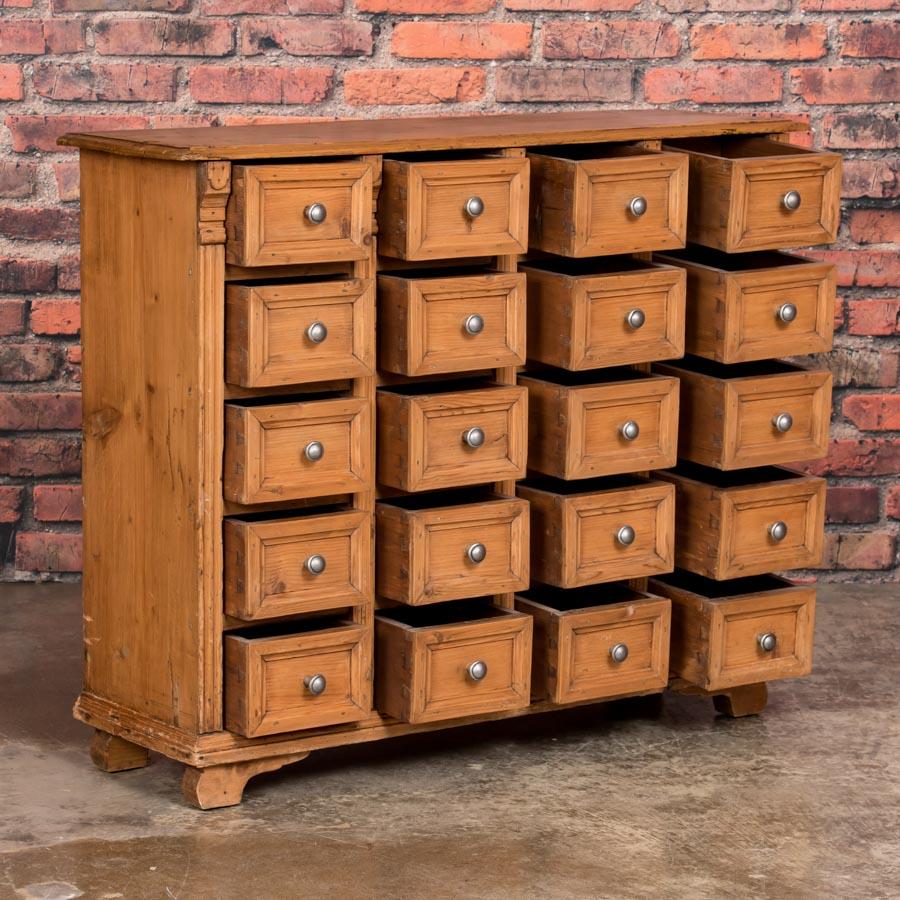 This unique Danish pine sideboard has a country apothecary look with a total of 20 drawers which creates great visual appeal along with unique storage options. The sideboard is in excellent condition sealed with a wax finish and very versatile - it
