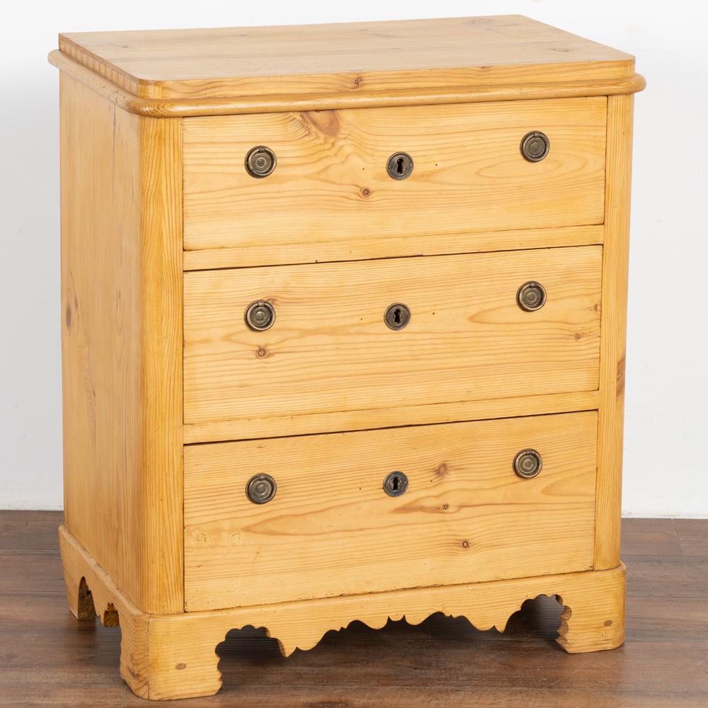 Antique pine nightstand or small chest of three drawers with natural wax finish.
Note the skirt with decorative scalloped carving. 
Restored, this nightstand is strong, stable and ready for use.
Any nicks, scratches or signs of wear reflect the