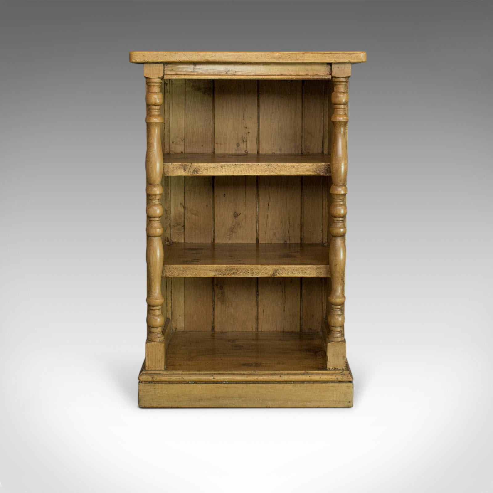 This is an antique pine open bookcase. A narrow, English, Victorian bookshelf dating to the late 19th century, circa 1900.

Select pine panels display warm caramel hues and fine grain interest
Pleasing Victorian country styling with a desirable