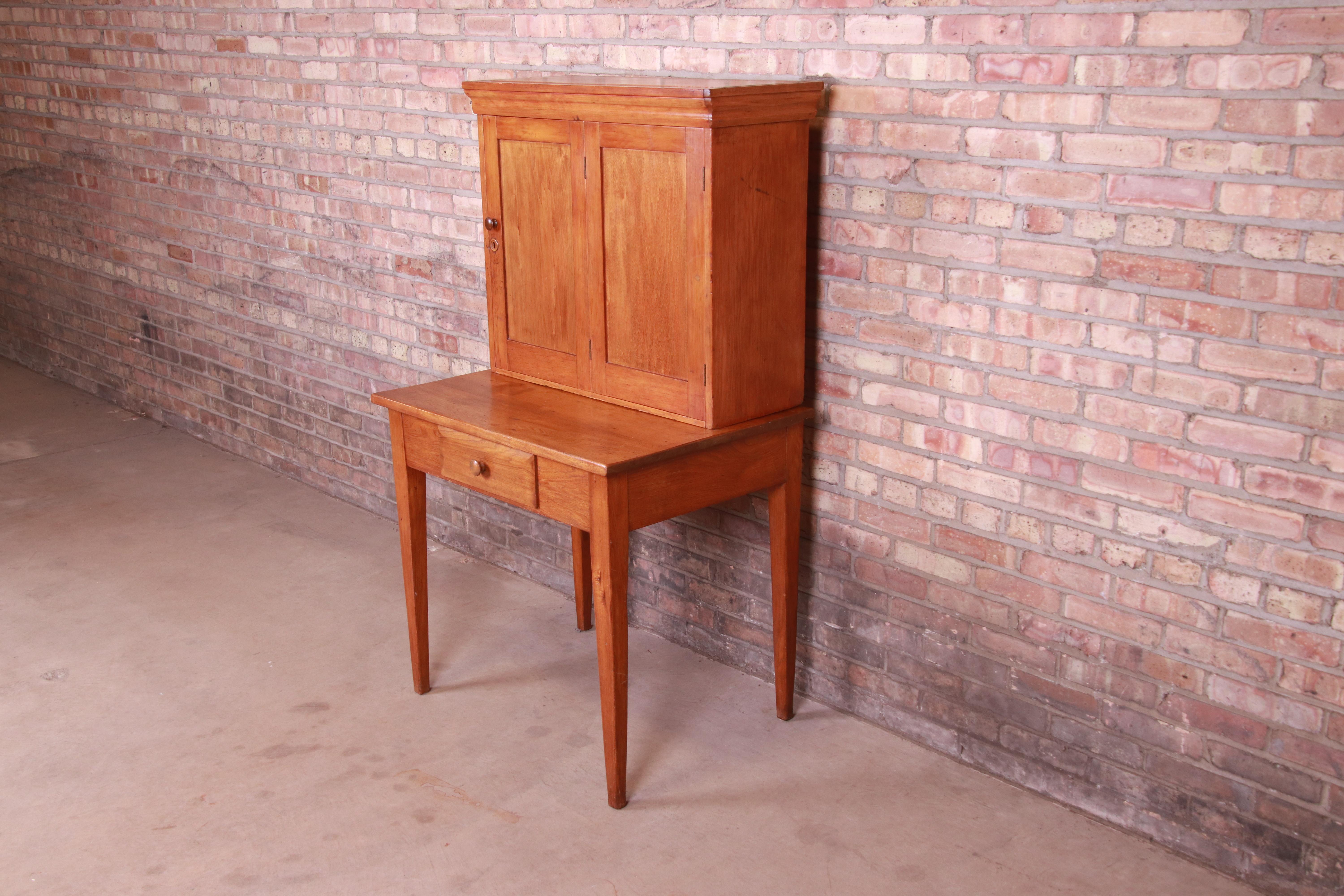 A unique solid pine postmaster or general store desk with fitted interior

USA, circa 1840s

Measures: 32