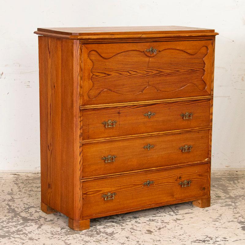 It is the passage of many years that has deepened the patina with such richness in this pine secretary from Sweden. The simple lines of this country piece are complimented by the warmth of the waxed pine finish. Notice the 15 petite interior drawers