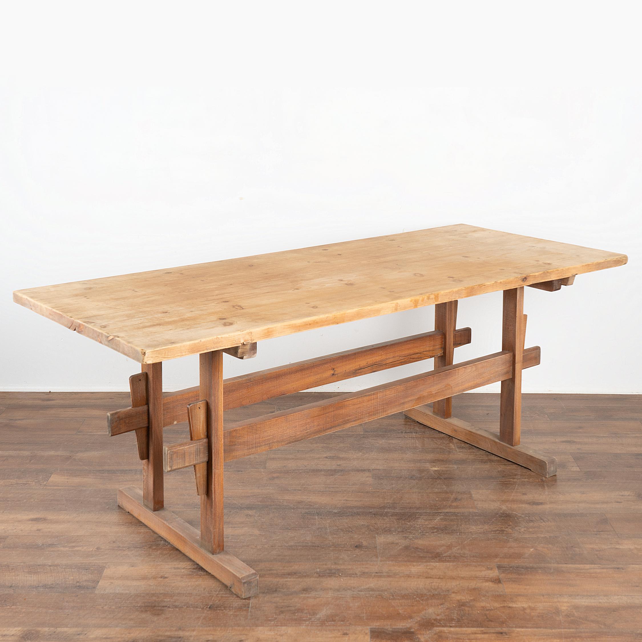 It is the double stretcher and wide platform feet of the base that give this wonderful pine trestle table table it's country charm in addition to strength and stability.
The top reveals old scratches, gouges, stains, nicks, etc. which all add to the