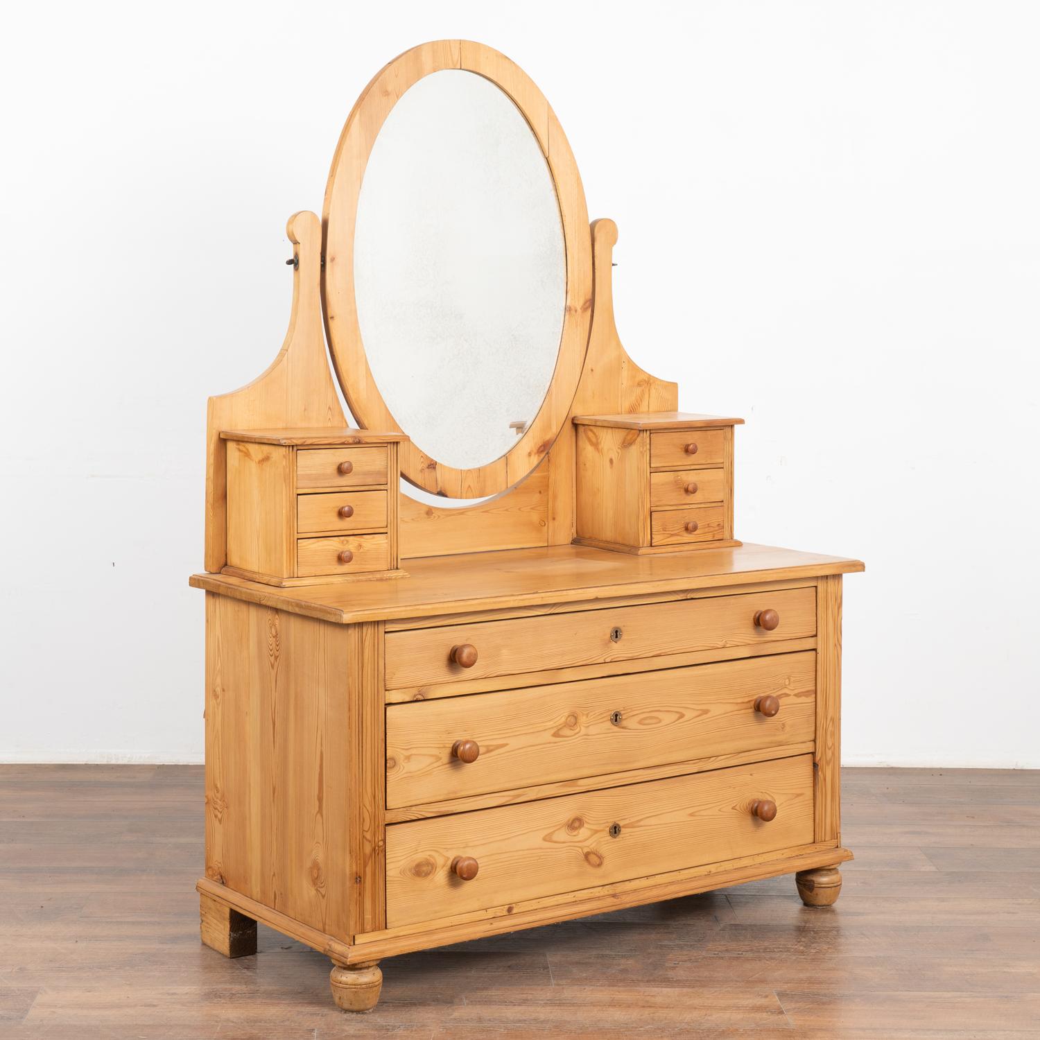 Lovely country pine vanity or dressing table with mirror.
Six small drawers, adjustable mirror, and three large lower drawers.
Restored, stable and ready for use. This vanity has been given a waxed finish.
All scratches, cracks, dings, or age