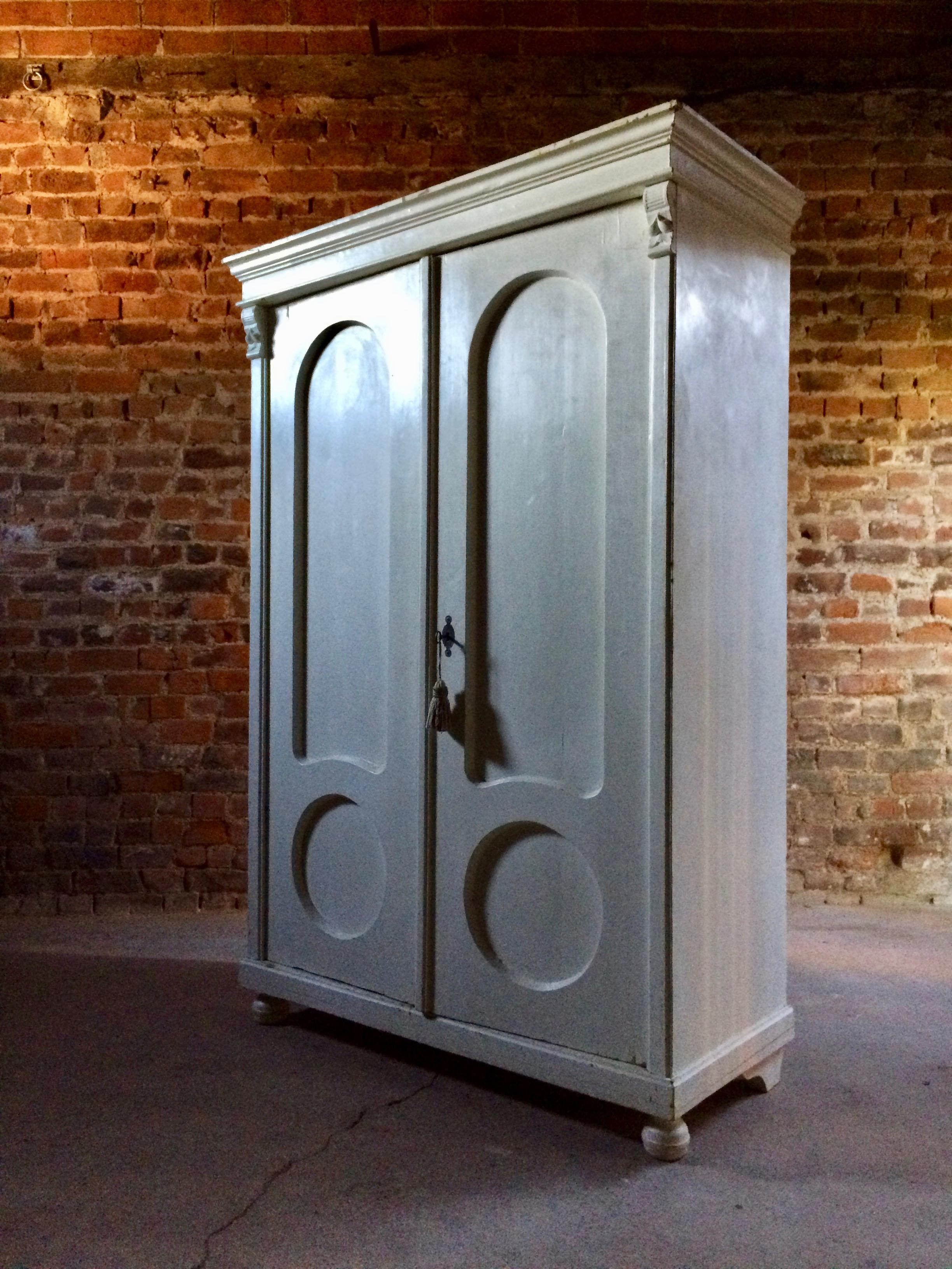 A fabulous antique 19th century French armoire wardrobe circa 1890, the moulded cornice above a pair of panelled doors enclosing a single hanging rail, raised on bun feet, comes with one working key with tassel.

Condition report: The cornice is