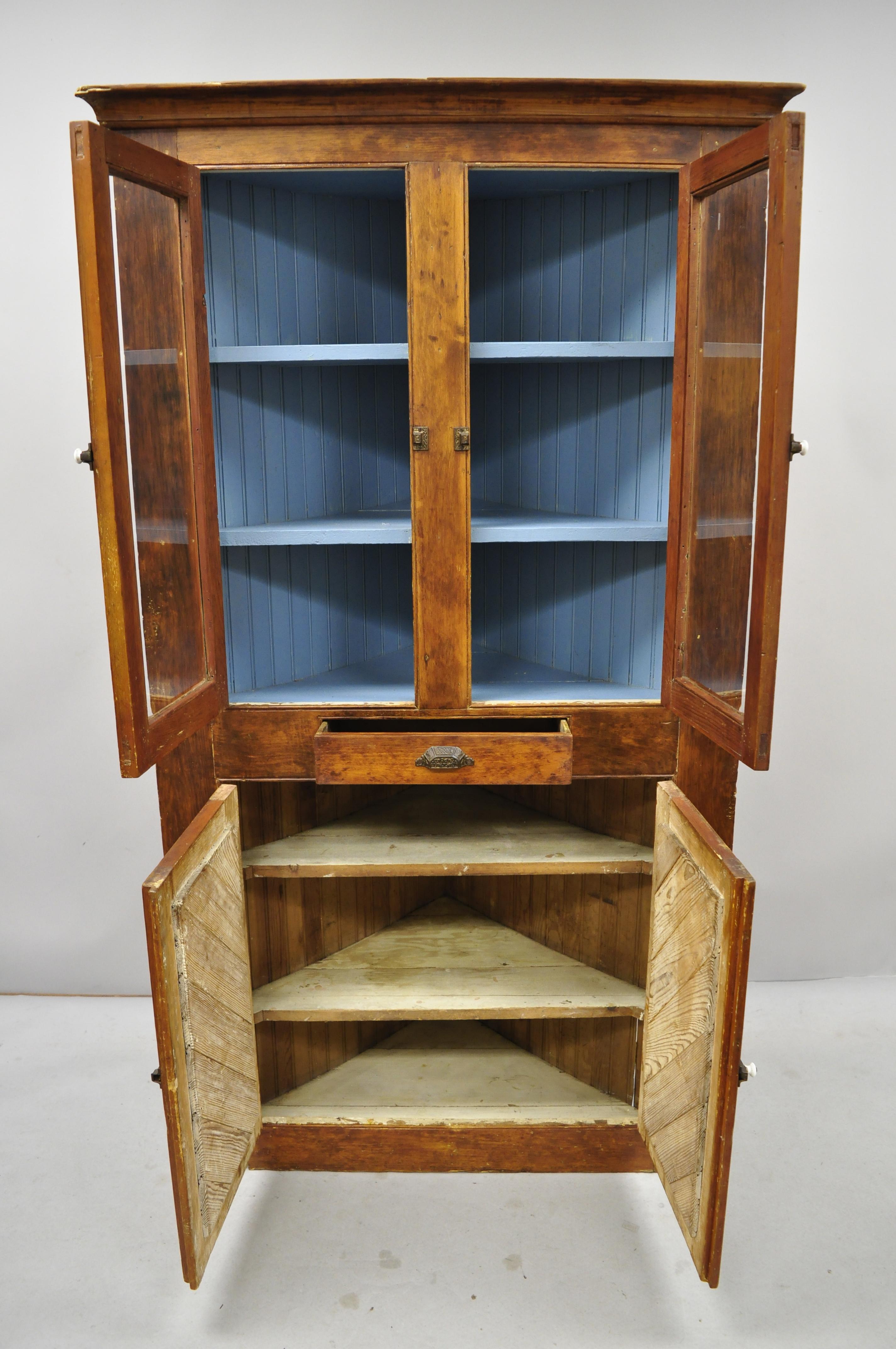 Antique pine wood Primitive Rustic corner China cabinet cupboard blue painted interior. Item includes a blue painted interior, upper glass doors, solid wood construction, beautiful wood grain, 4 swing doors, 1 drawer, very nice antique item, quality