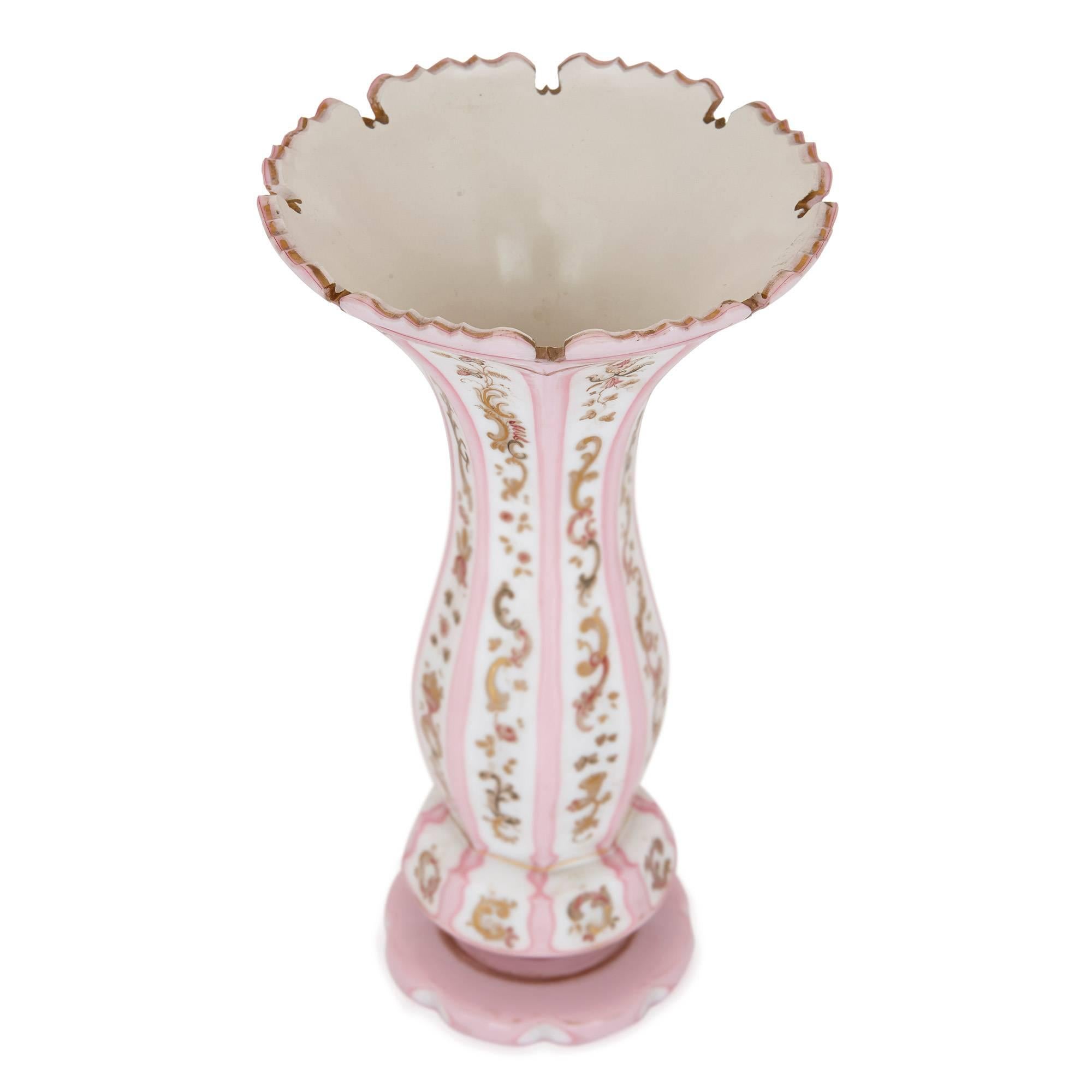 This slender, elegant glass vase is testament to the quality of Bohemian glass-making in the 19th century. Featuring parcel-gilt detailing and a white and pink color palette, this vase is well suited to a range of interior styles and settings. The