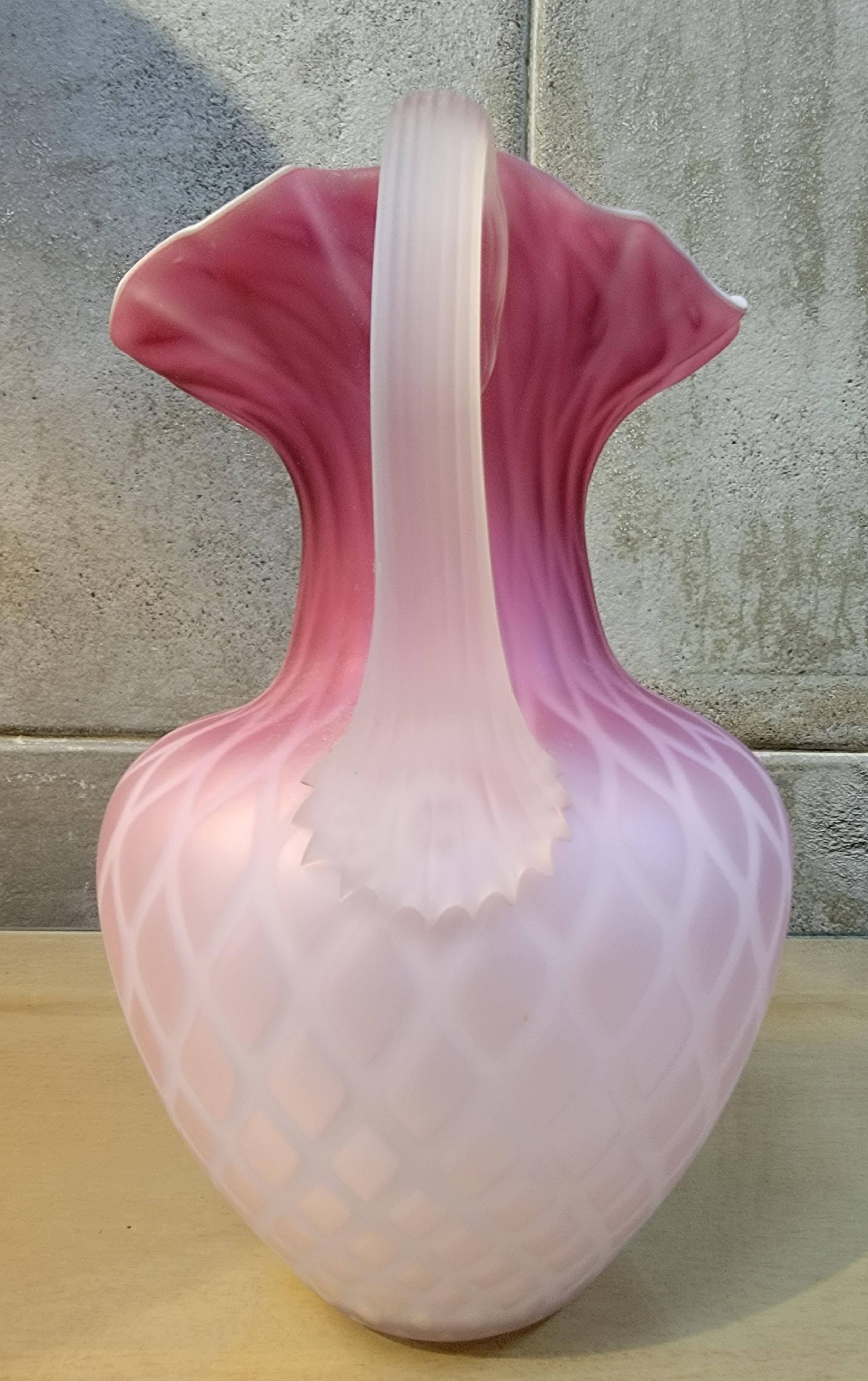 A late 19th century cased glass pitcher. Circa. 1890. Beautiful pink and white diamond quilted pattern. Excellent original condition.