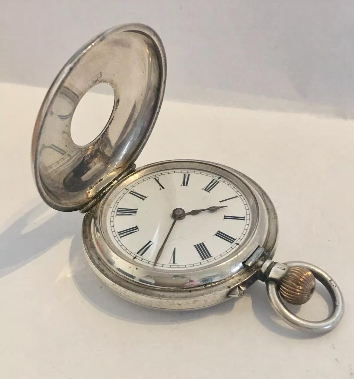 This beautiful silver and pink enamel half hunter small pocket watch is in good working order. But I cannot guarantee the time accuracy. The top cover glass is missing.
