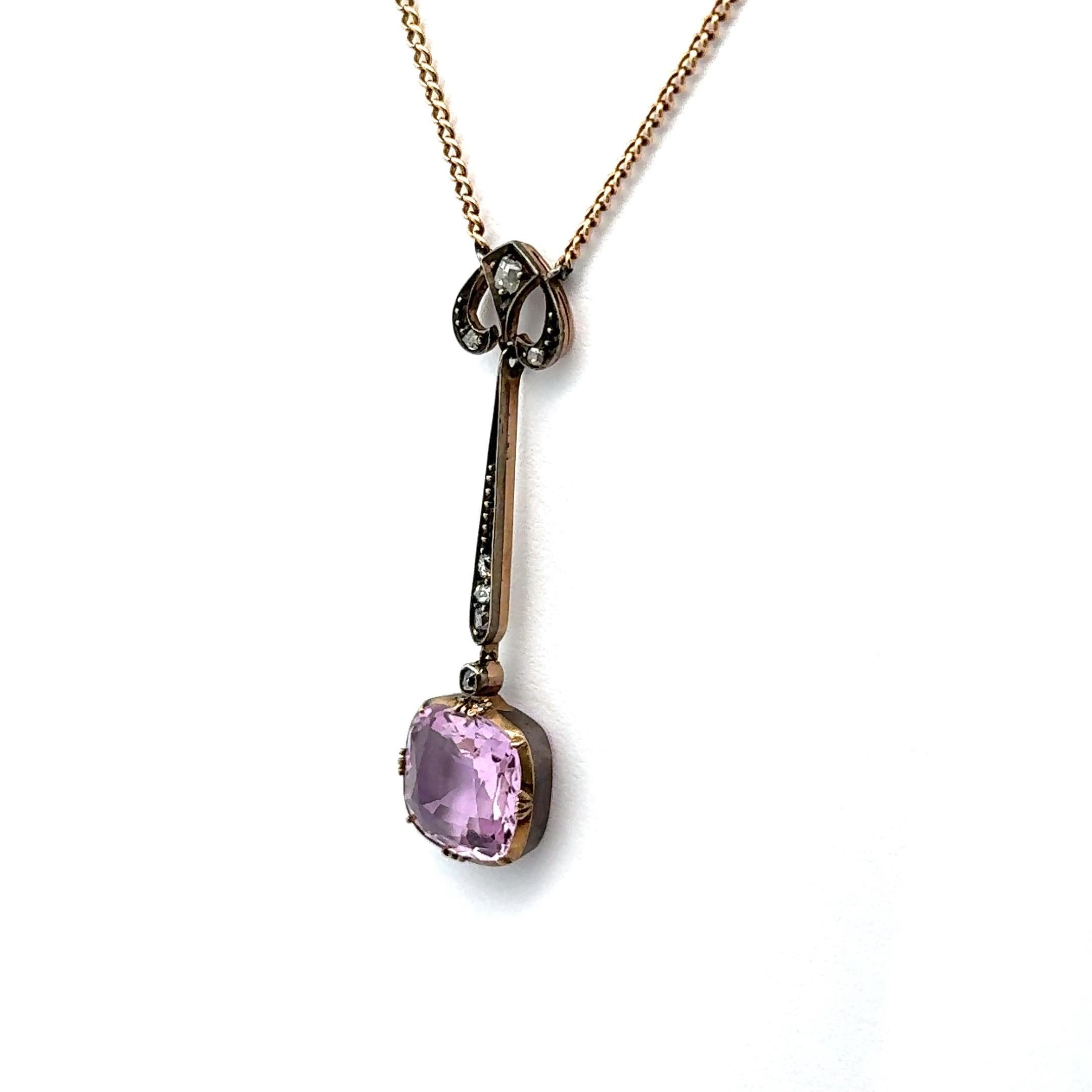 This elegant drop necklace features a captivating 5.0 carat cushion-cut pink topaz as its centerpiece. The pendant is meticulously crafted with a combination of 14k gold and silver, highlighted by a delicate yellow gold setting. Accentuating the