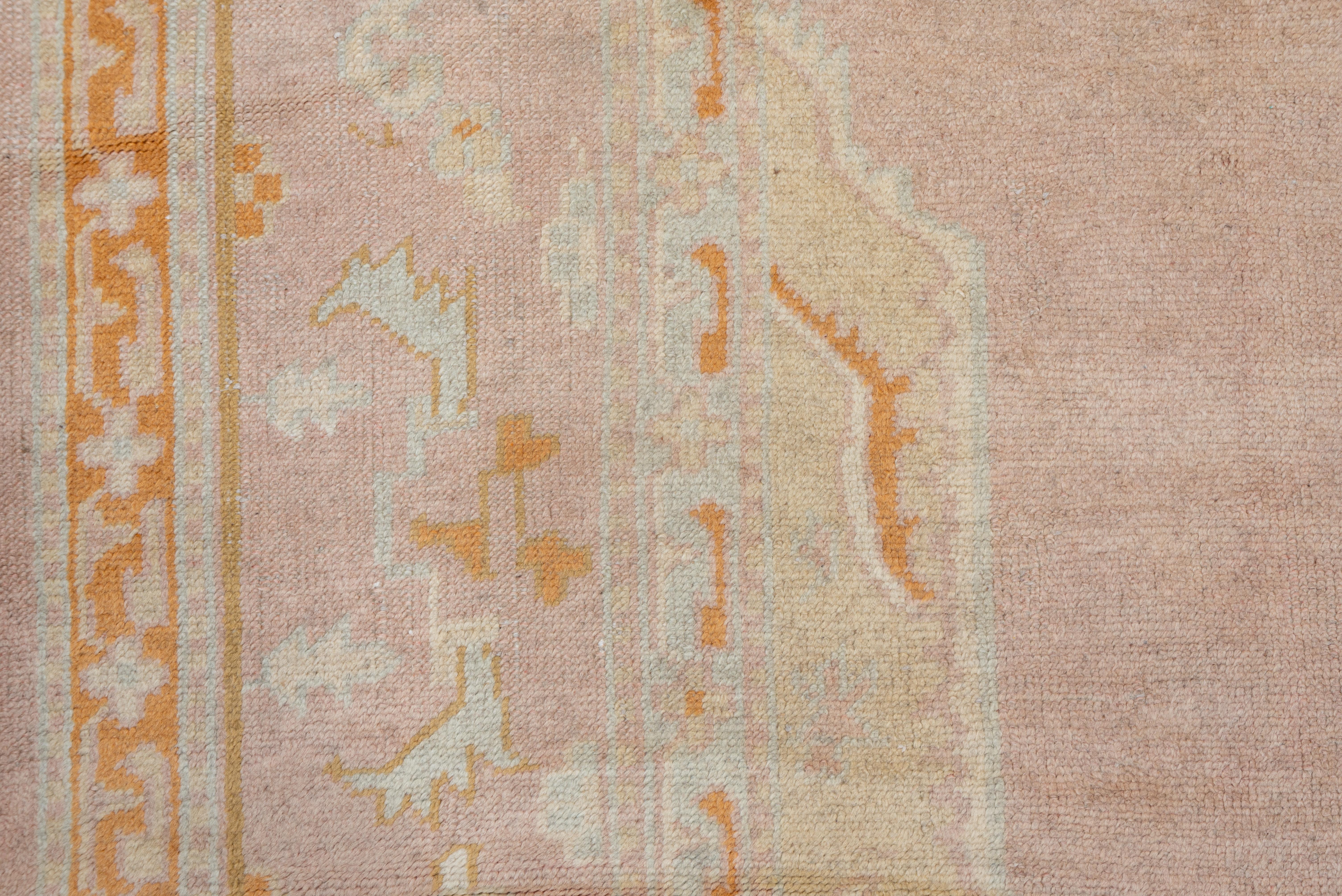 Wool Antique Pink Turkish Oushak Carpet with Orange & Yellow Accents, circa 1920s For Sale