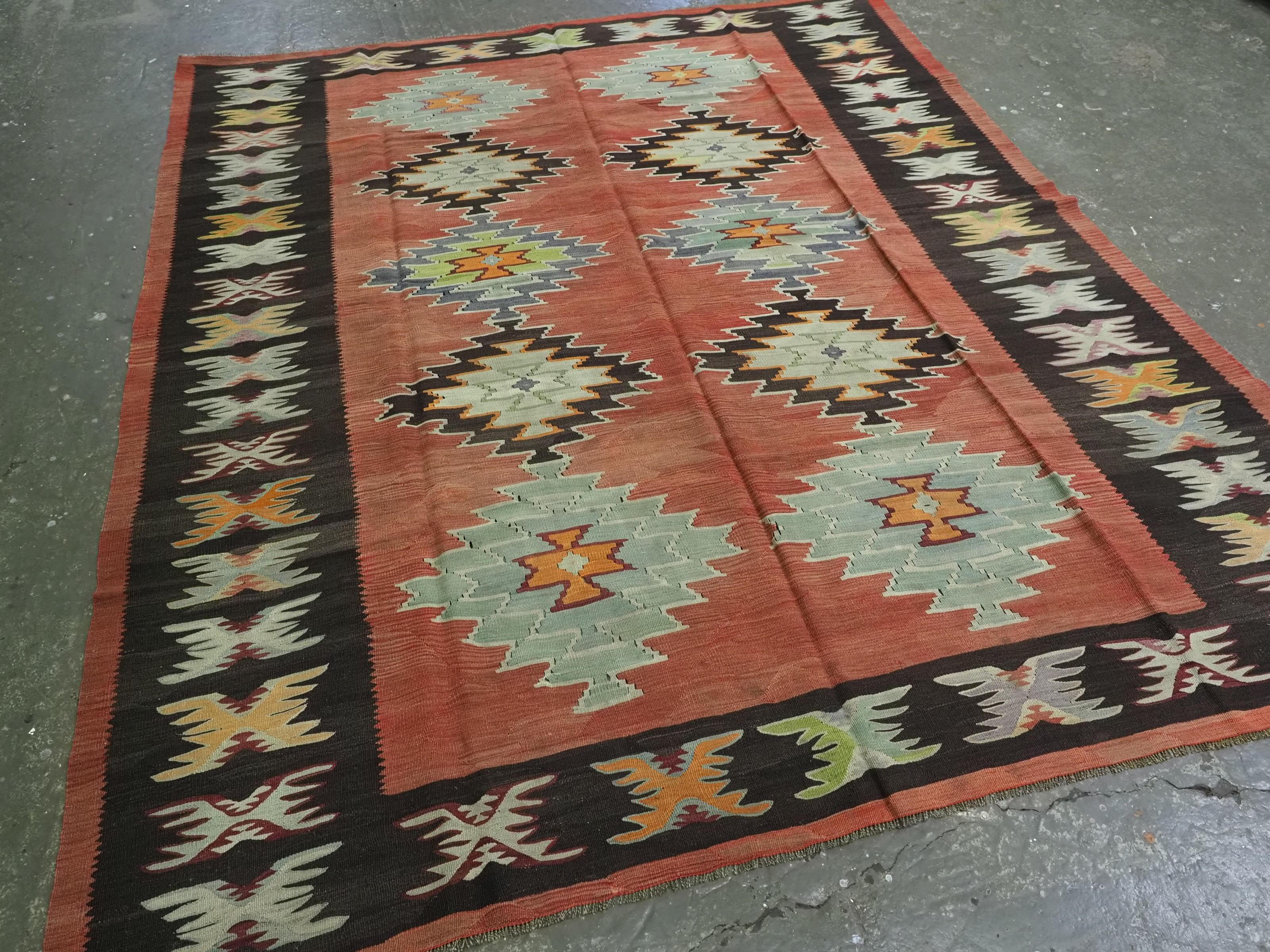 Size: 9ft 1in x 7ft 7in (278 x 231cm).

Antique Pirot / Sarkoy kilim of repeat diamond medallion design. A kilim of good room size with outstanding colour.

Circa 1920.

Pirot kilims are also known as Sarkoy or Sharkoy, they originate from the town