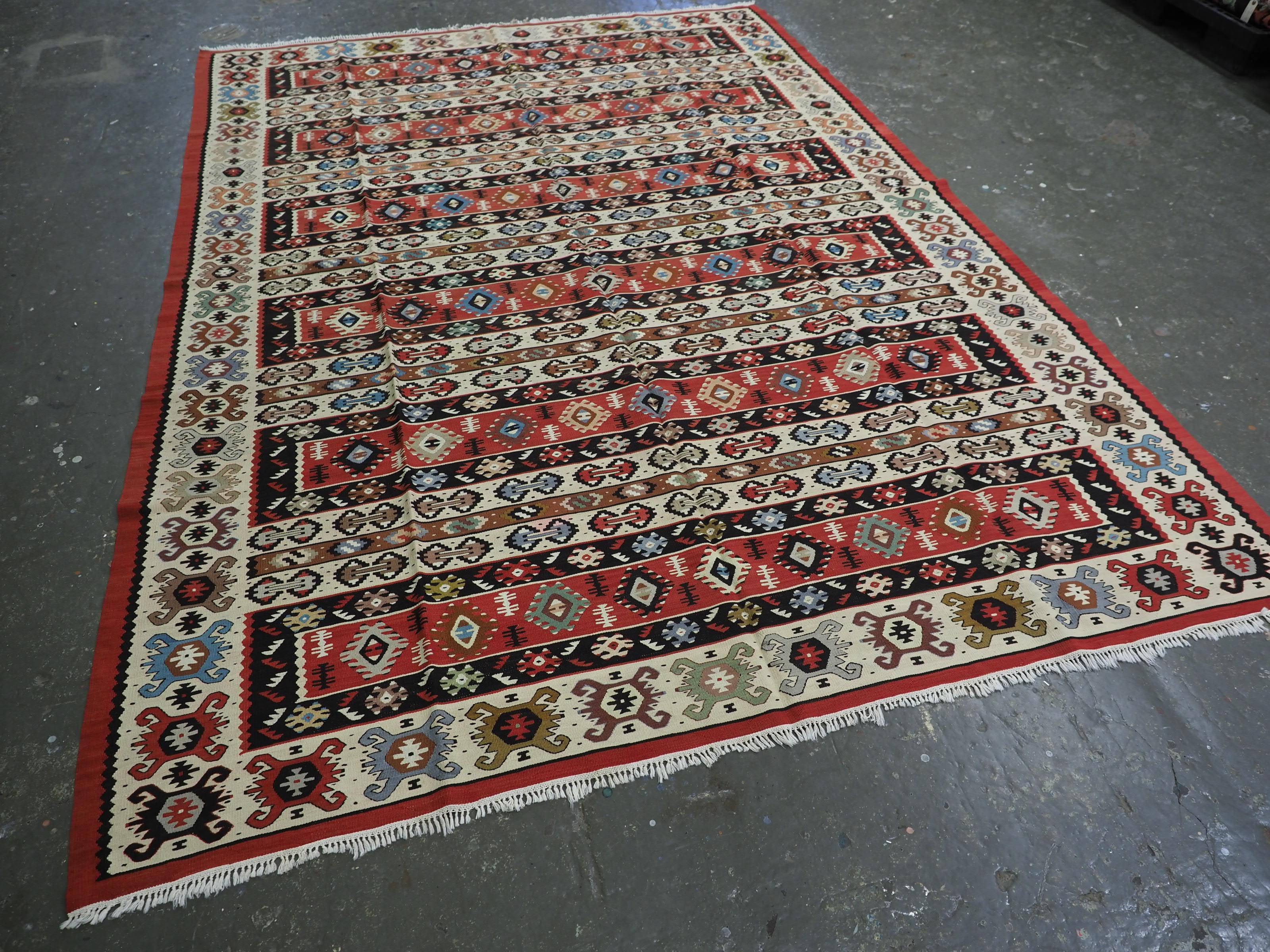 Size: 9ft 9in x 6ft 11in (297 x 210cm).

Antique Pirot / Sarkoy kilim of traditional banded design. A kilim of good room size.

Circa 1920.

Pirot kilims are also known as Sarkoy or Sharkoy, they originate from the town of Pirot in south-eastern
