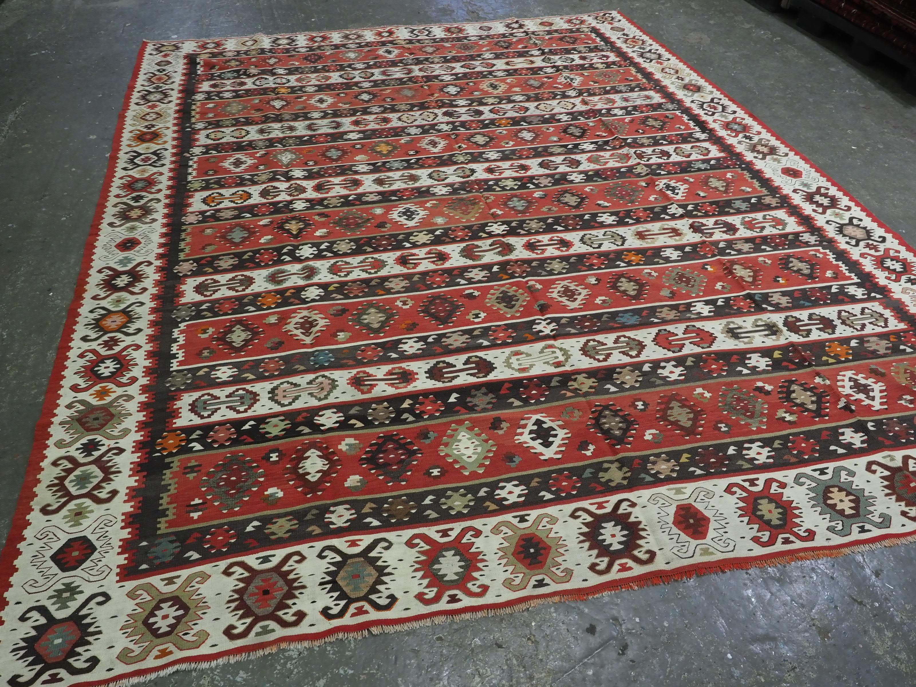 
Size: 10ft 11in x 9ft 1in (334 x 278cm).

Antique Pirot / Sarkoy kilim of traditional banded design. A kilim of large room size.

Circa 1920.

Pirot kilims are also known as Sarkoy or Sharkoy, they originate from the town of Pirot in south-eastern