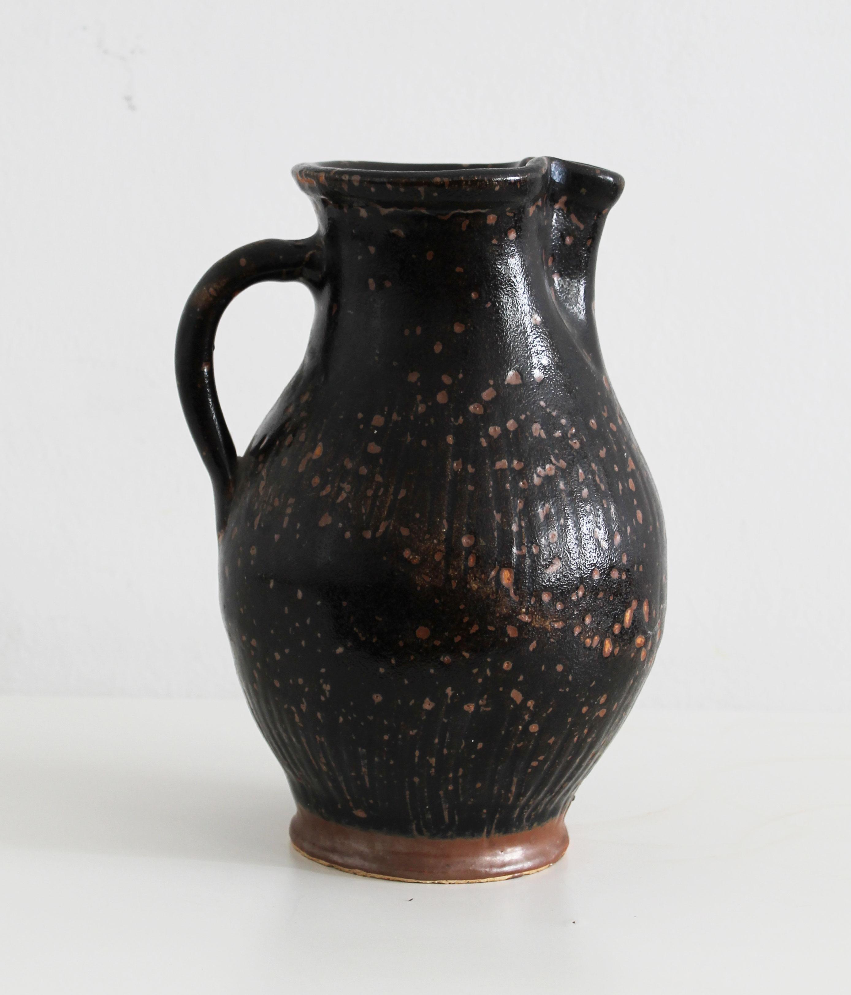 Late 19th Century Antique pitcher made of dark glazed stoneware For Sale