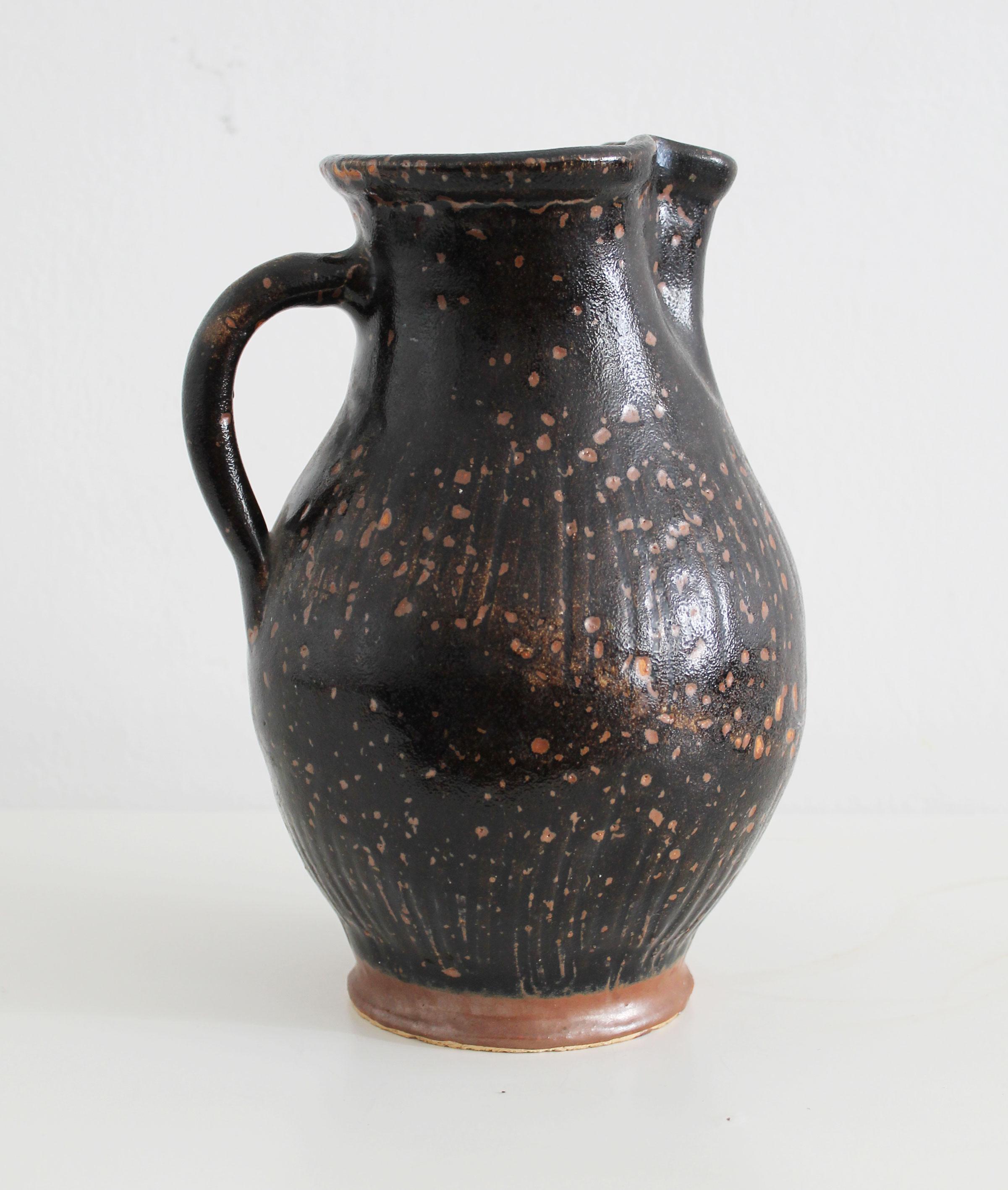 Antique pitcher made of dark glazed stoneware For Sale 1