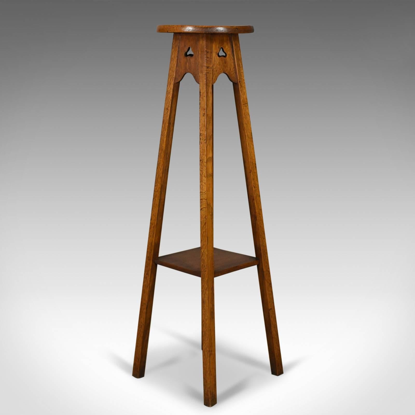 This is an antique plant stand, an Arts & Crafts torchere in the Liberty taste. Crafted in English oak and dating to circa 1910 in the Edwardian period.

Liberty-esque in it's simplicity and quality
Beautifully crafted in select English