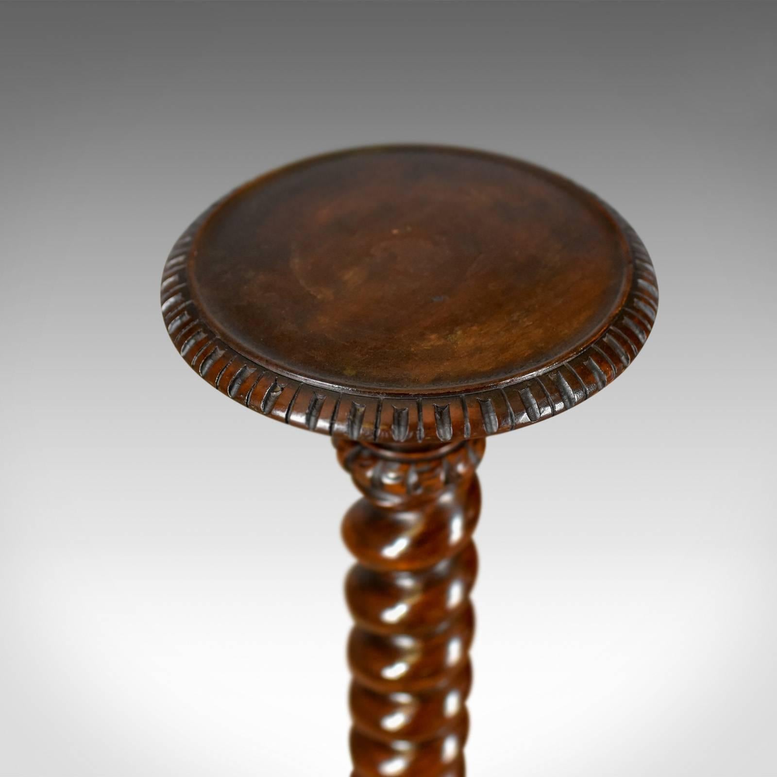 This is an antique plant stand, an English, Victorian torchere dating to the end of the 19th century, circa 1900.

Delightful, tapering barley twist stem
Rising from ring turned and carved base
Anchored in a broad, carved platform
Standing upon