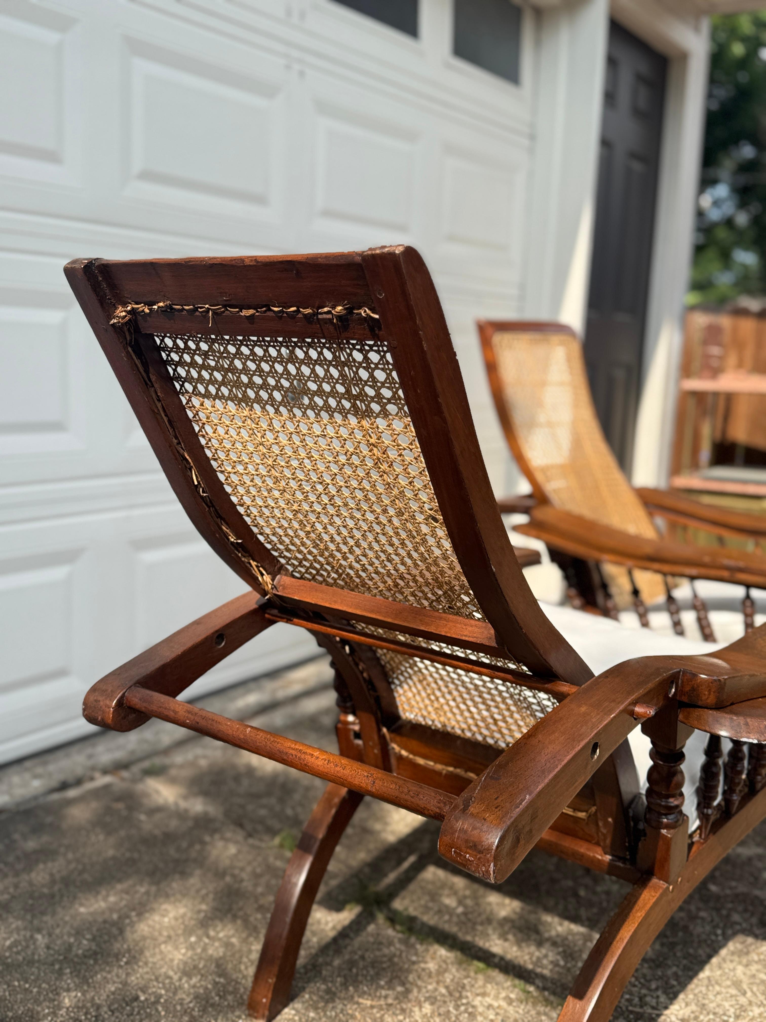 Antique plantation chair with handwoven cane and fold out footrests, circa 1920S For Sale 6