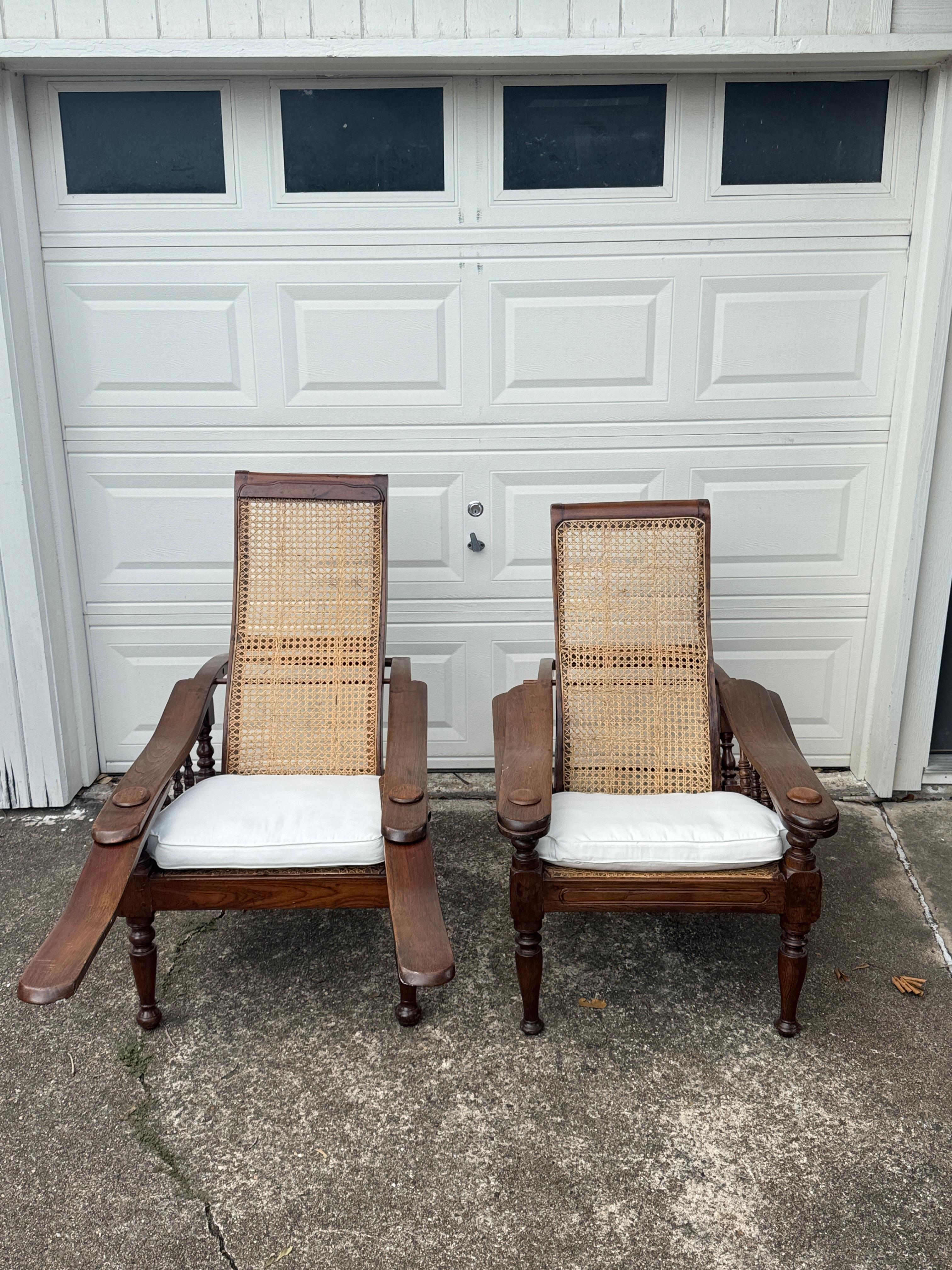 Antique plantation chair with handwoven cane and fold out footrests, circa 1920s(30s?). This reclining lounge chair has an adjustable rattan backrest thats secured with solid port pegs, and the fold out paddle style footrest offers added comfort.