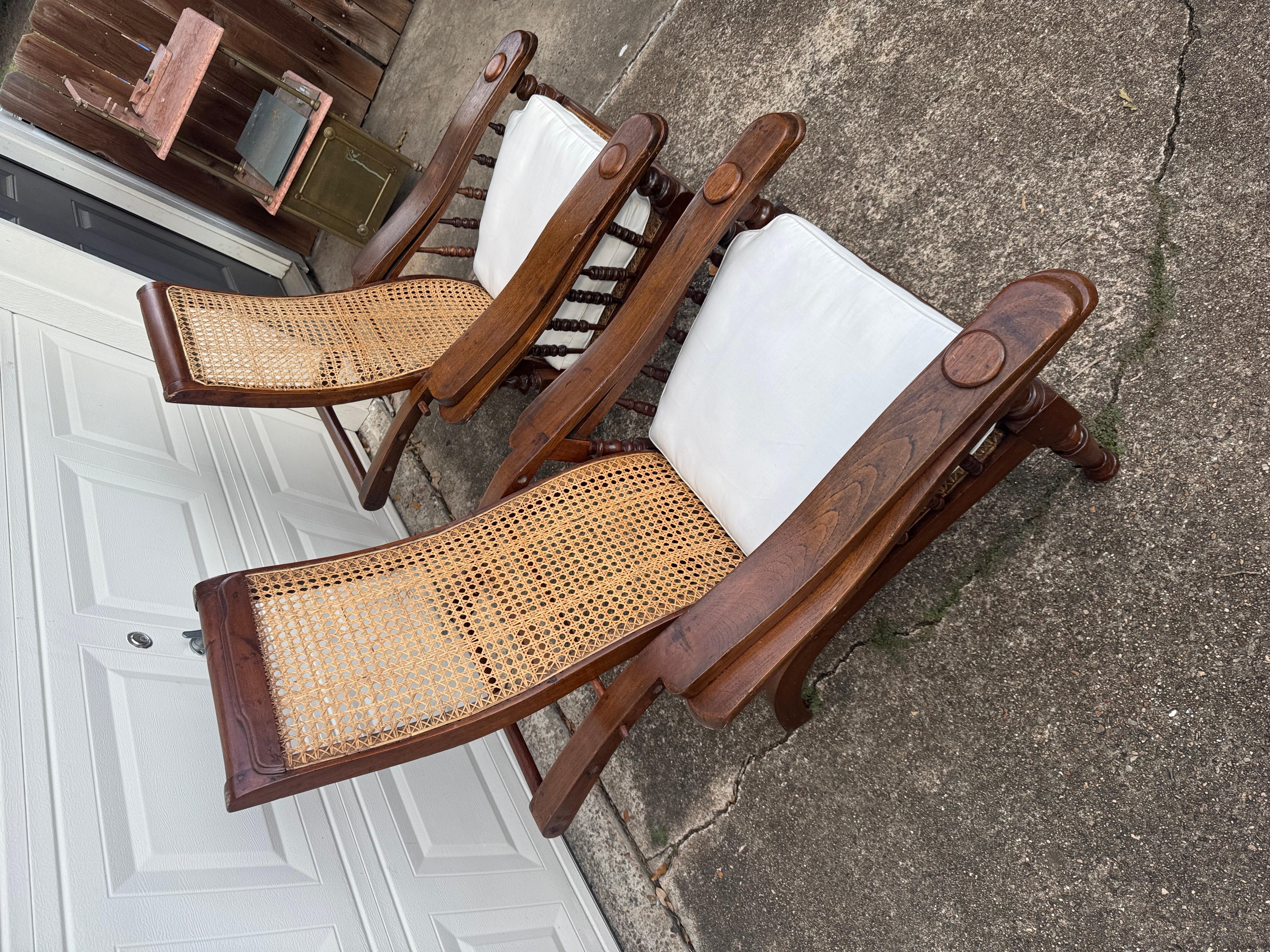 20th Century Antique plantation chair with handwoven cane and fold out footrests, circa 1920S For Sale