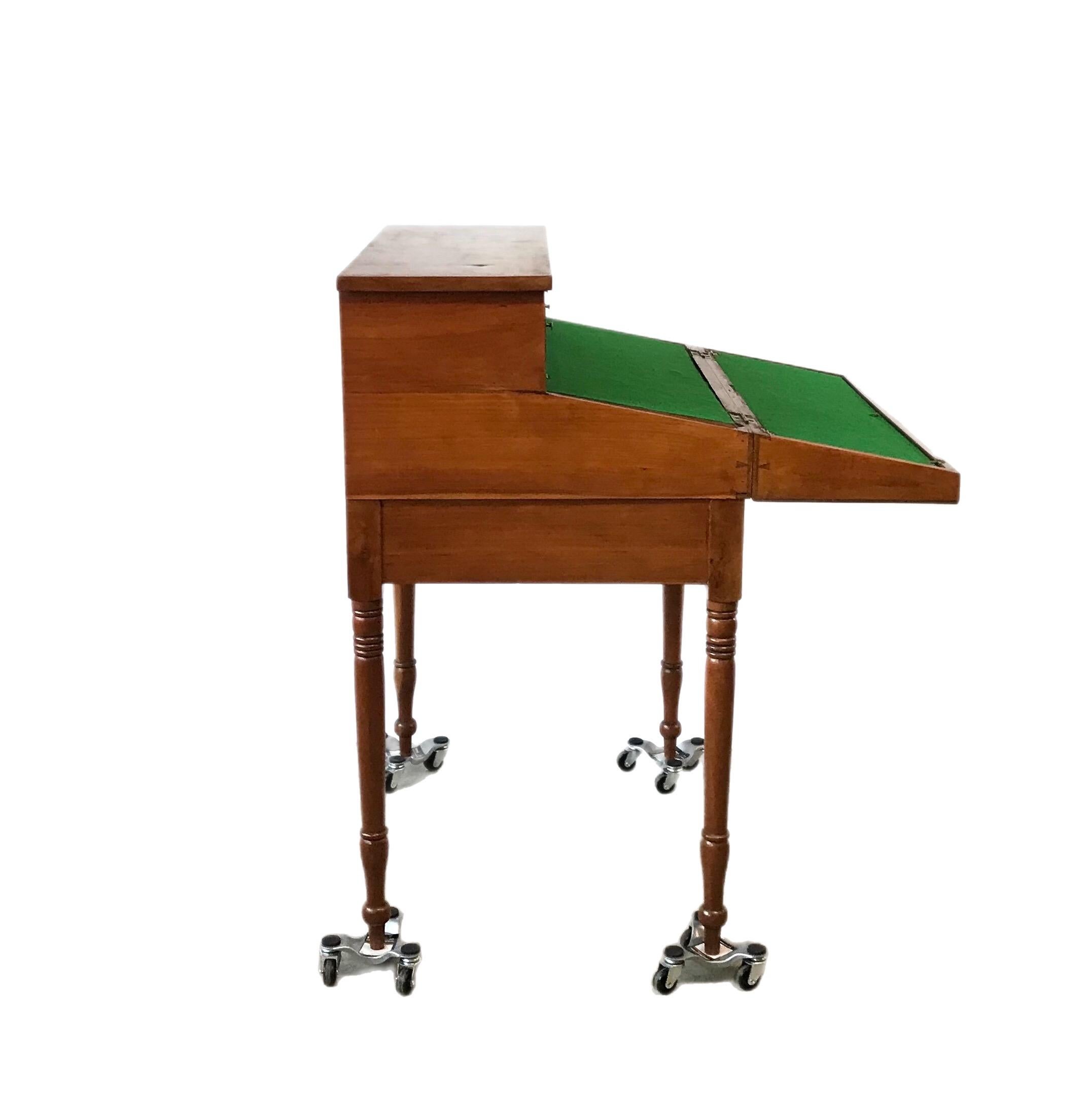Uniques Sheraton styled plantation desk with folding top, when extended reveals a hideaway compartment for document storage. The two top drawers are in a fixed, locked position when the top is folded and secured. Piece features a third bottom drawer