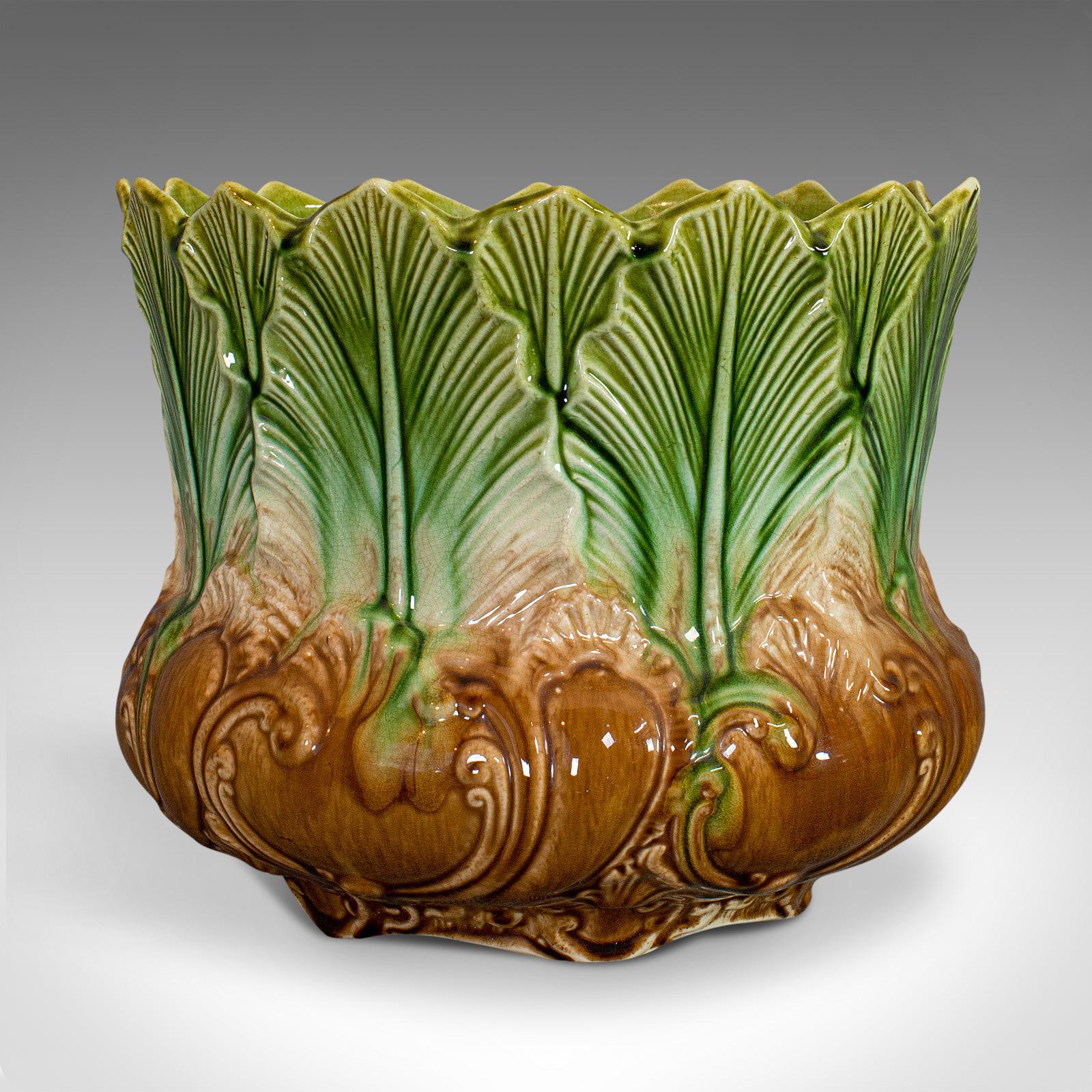 This is an antique planter. An English, Majolica glaze New Leaf jardinière in Art Nouveau taste, dating to the late Victorian period, circa 1900.

Eye-catching, Art Nouveau decorative planter
Displays a desirable aged patina
Verdant green and