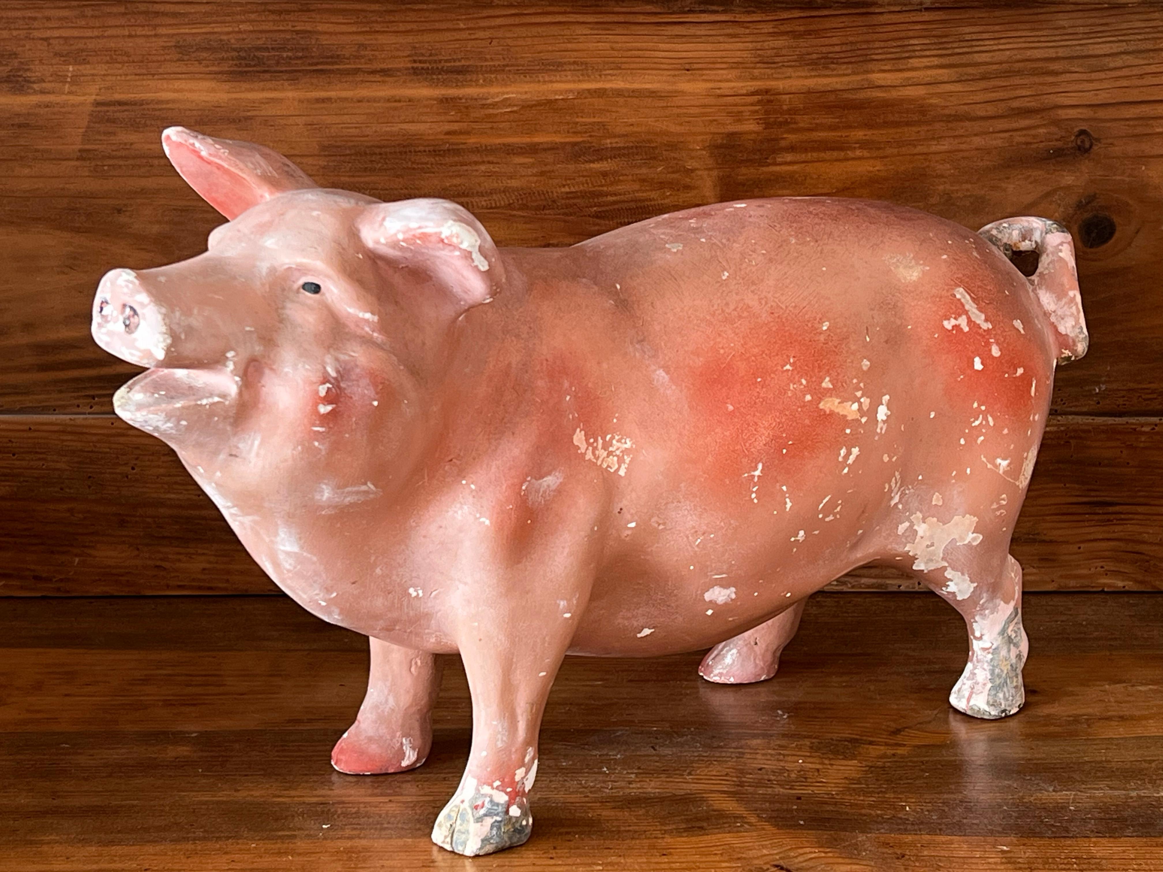 Painted plaster pig from the first half of the 20th century, originating from France. Originally, these plaster sculptures were displayed in shop windows or in butchers' and delicatessens. It bears the marks of time, which give it its charm, but it