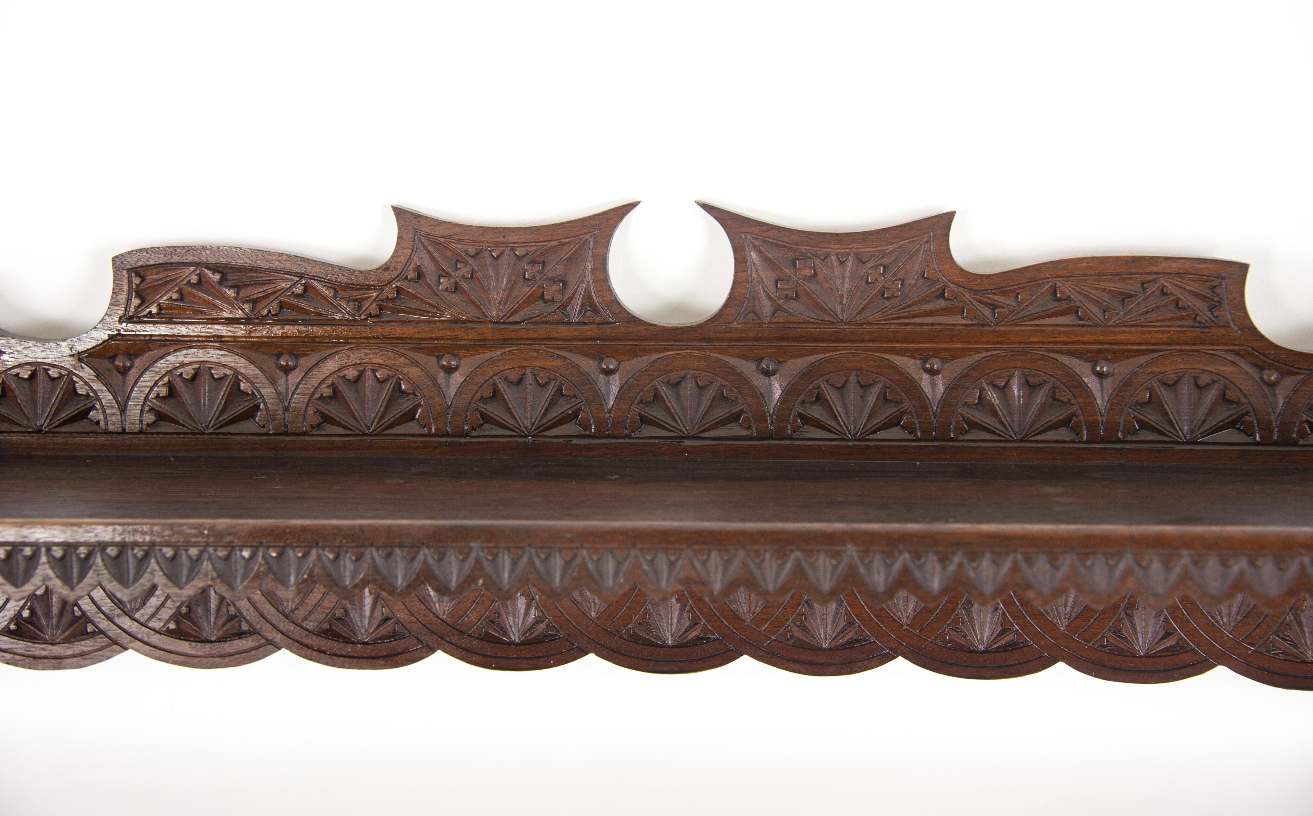 Antique plate rack, solid walnut, Victorian, chip carved, hanging shelf, Scotland, 1880

Scotland, 1889
Solid walnut construction
Original finish
Smothered in crisp chip carving
Full shelf above
Three shelves below are grooved for the plats to sit