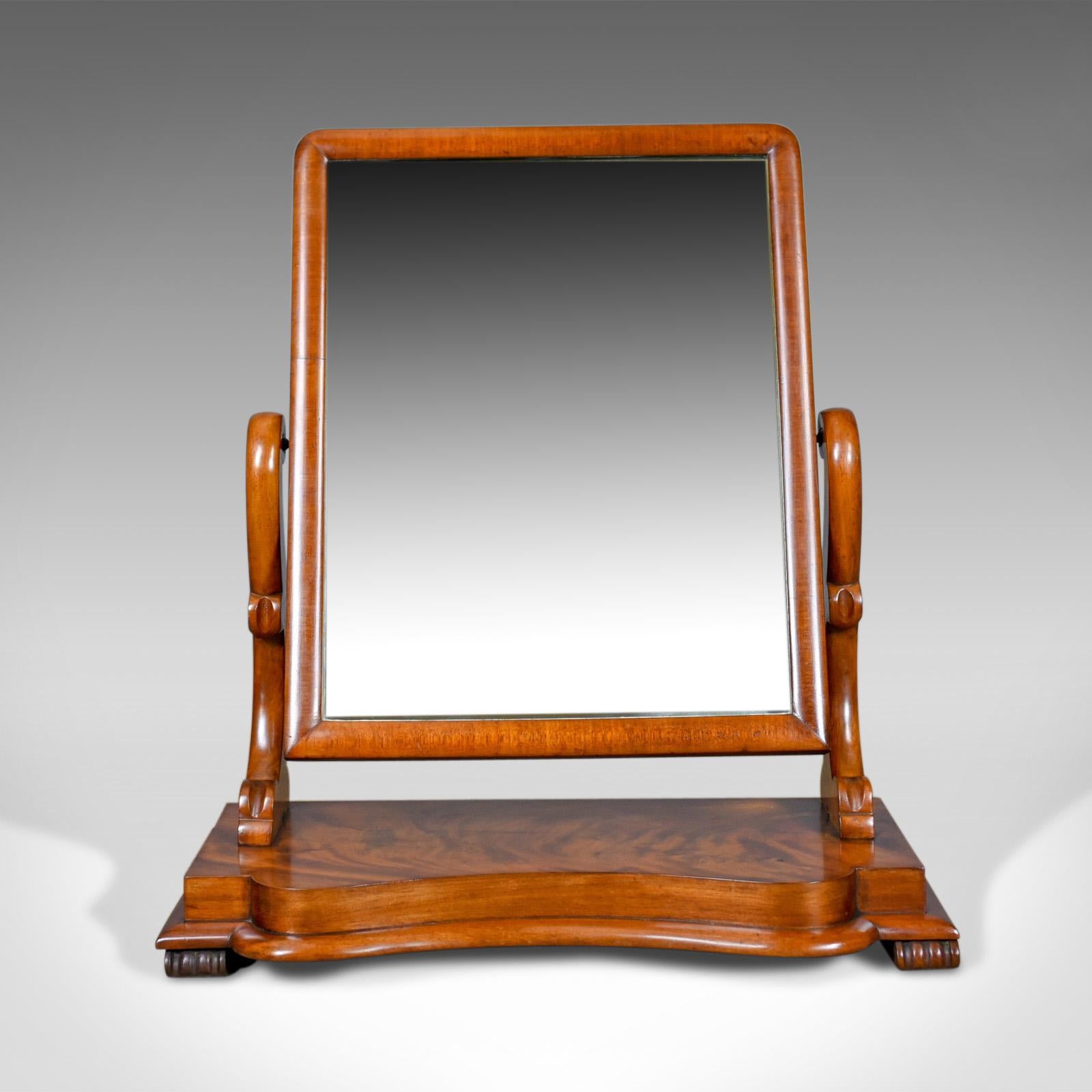 This is an antique platform mirror in flame mahogany. English Victorian vanity, dating to the 19th century, circa 1870.

A large adjustable platform, vanity mirror
Flame mahogany displaying grain interest and a desirable aged patina
Good