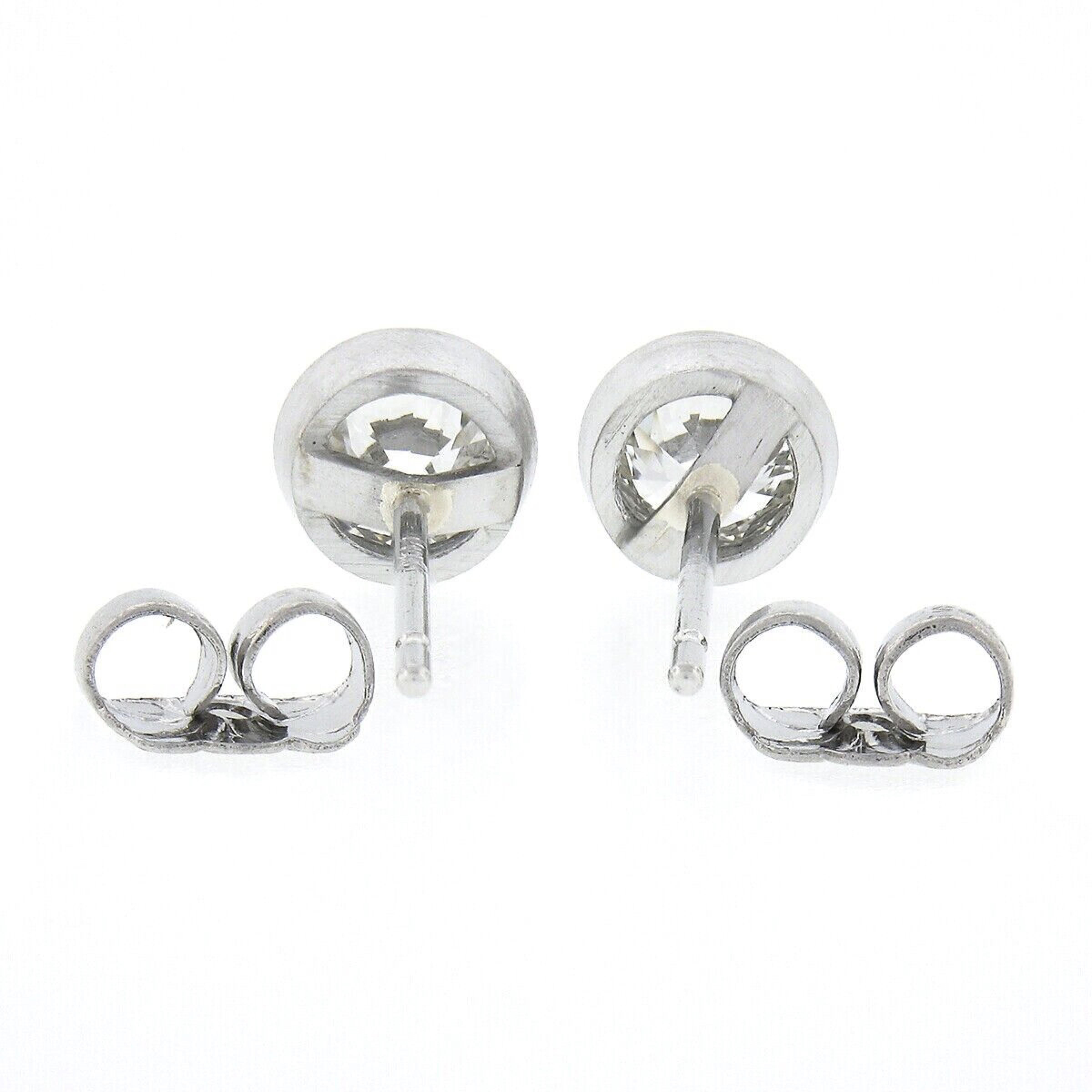 Here we have an outstanding pair of classically styled diamond stud earrings. They feature a pair of genuine antique diamonds with an old European cut that together total exactly 0.82 carats in weight. These magnificent diamonds are neatly bezel set