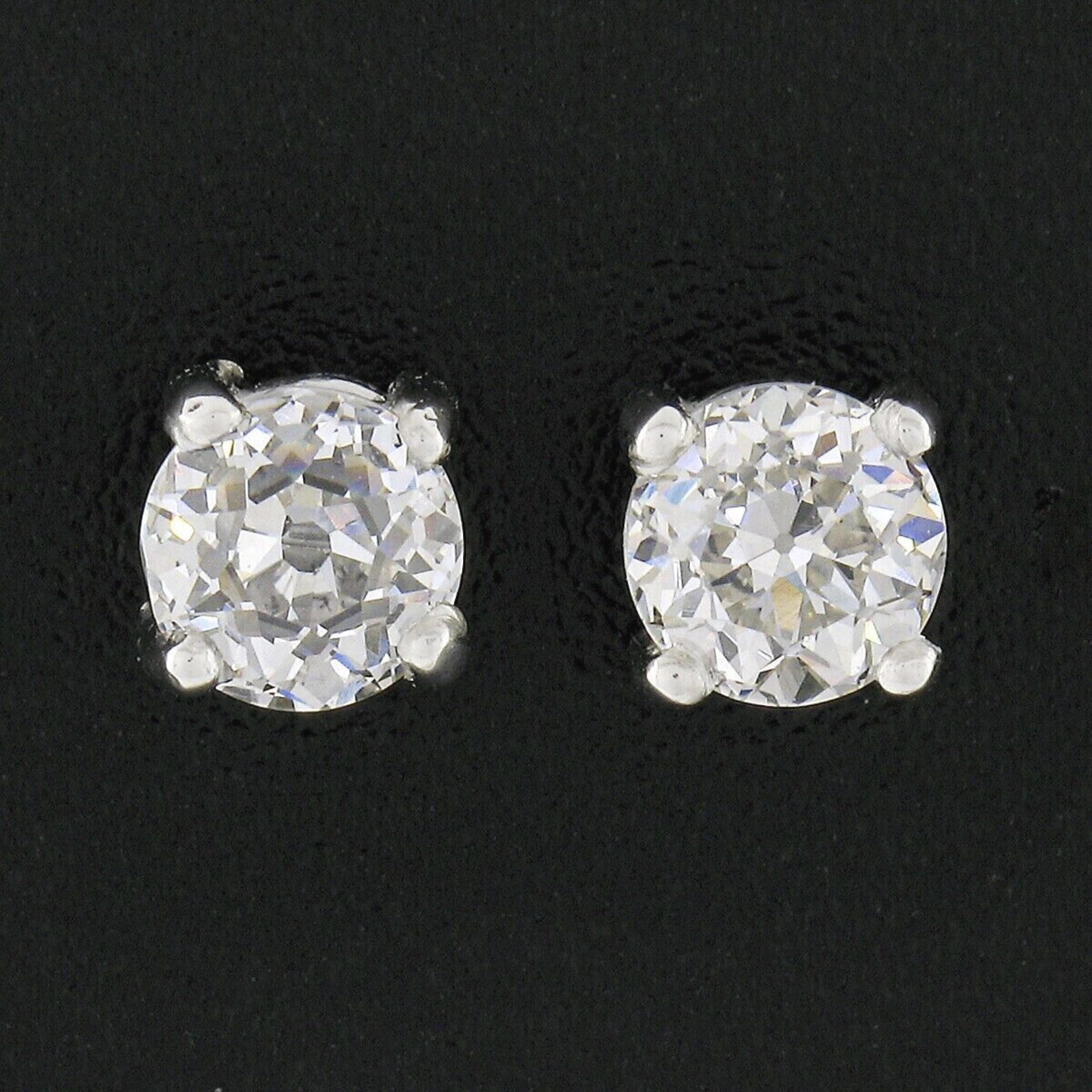 Here we have an outstanding pair of classically styled diamond stud earrings. They feature a pair of genuine, antique, diamonds that are each GIA certified with an old European and round brilliant cut, weighing a total of exactly 1.02 carats in
