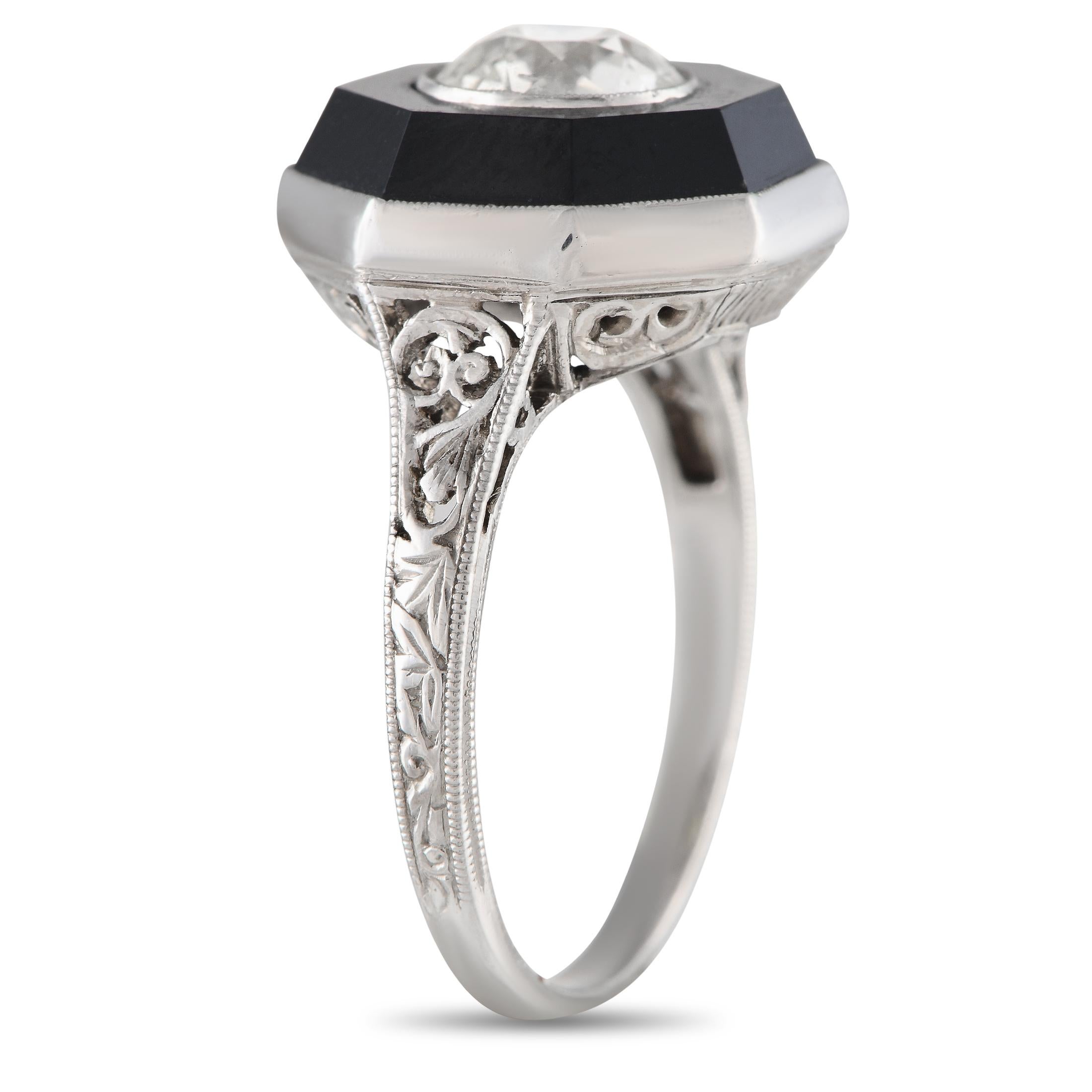 Dating back to the Art Deco era, here is an exquisite ring sure to make a dramatic style statement. It features a slim band that measures only 1mm thick. The ring's sculpted and milgrain-detailed shoulders lead to an octagonal centerpiece topped