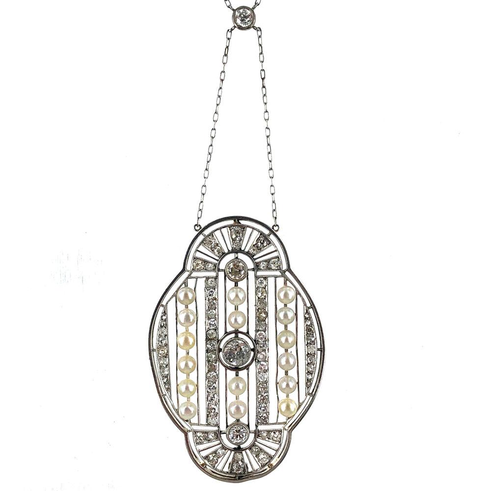 This magnificant antique filigree pendant is crafted in platinum and 18 karat white gold. The pendant features 70 Old European Cut diamonds that equal approximately 3.00 carat total weight and 16 natural pearls. The pendant measures 35 x 55mm, and