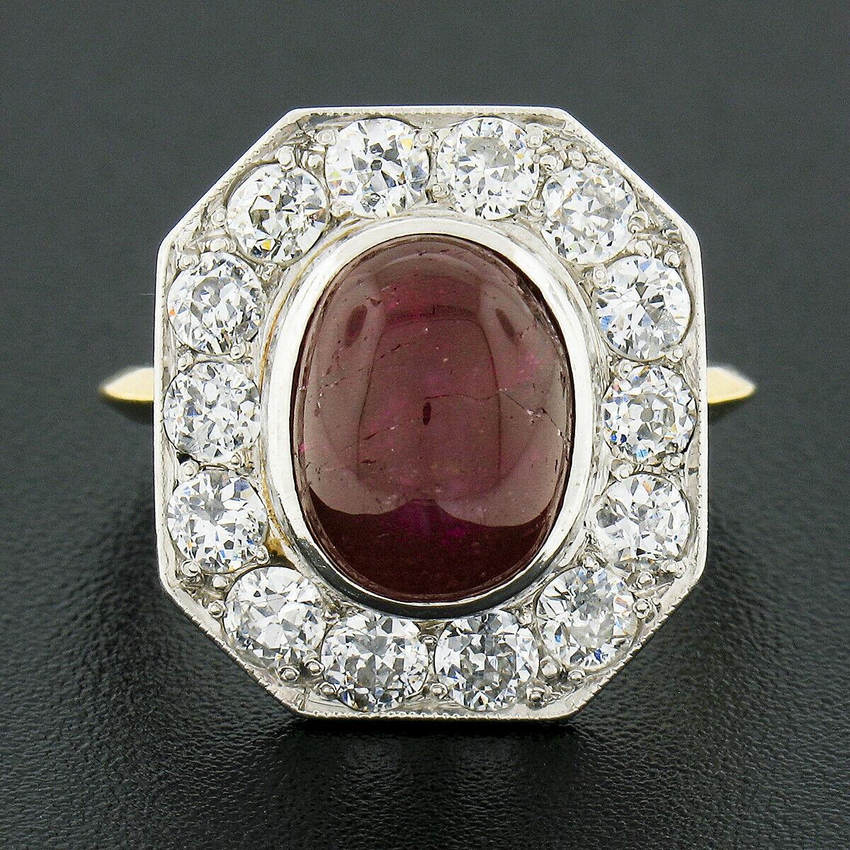 You are looking at an absolutely gorgeous antique cocktail ring that was crafted during the 1910's from solid 18k yellow gold with a platinum top. The ring features an oval cabochon cut ruby at its center, in which is neatly bezel set displaying a