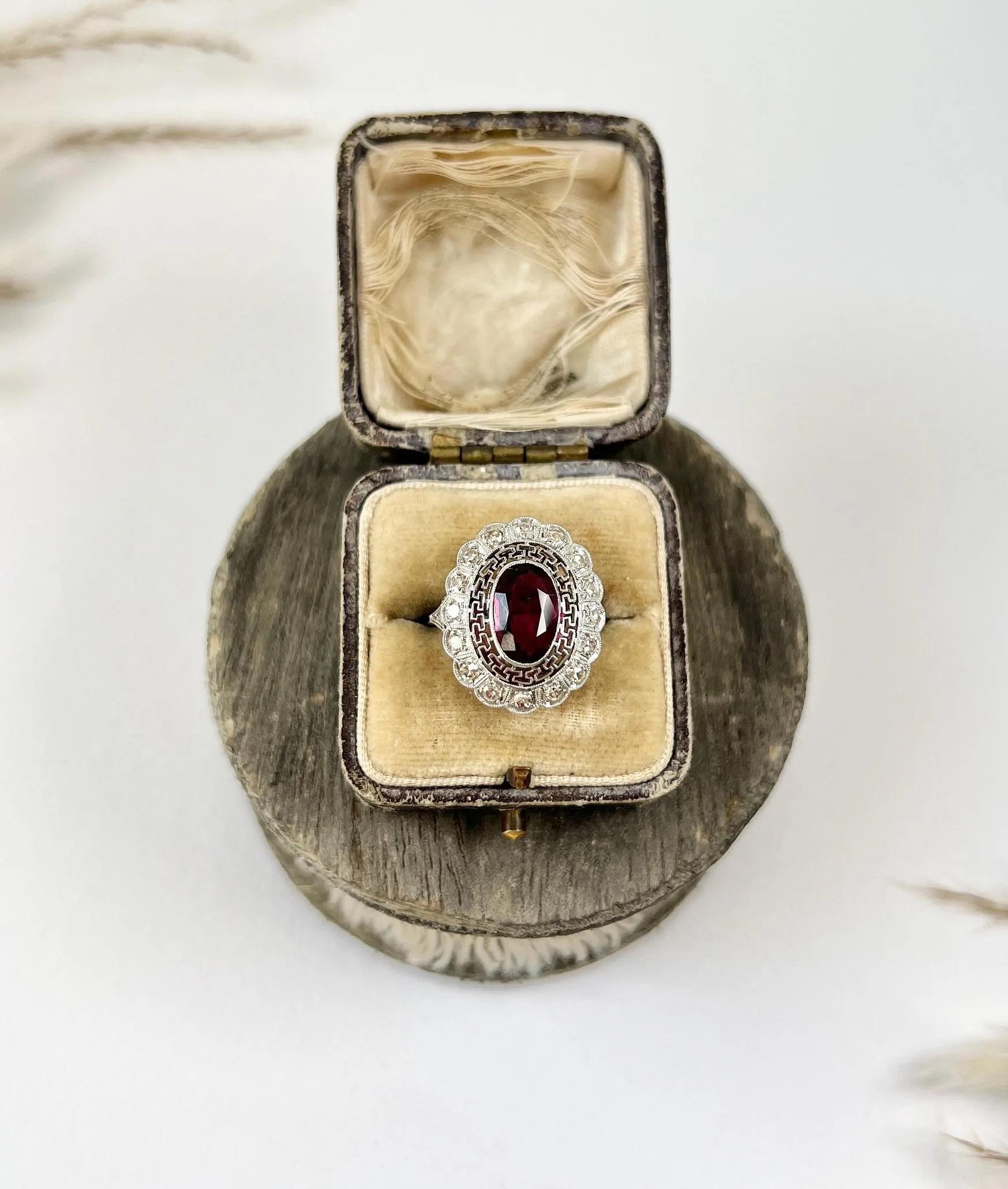 Antique Pink Tourmaline Ring 

Platinum Tested

Circa 1920s

This stunning platinum ring features a centre oval pink tourmaline stone, evoking the elegance of the 1920s art deco era. The intricate platinum fretwork and outer halo of sparkling