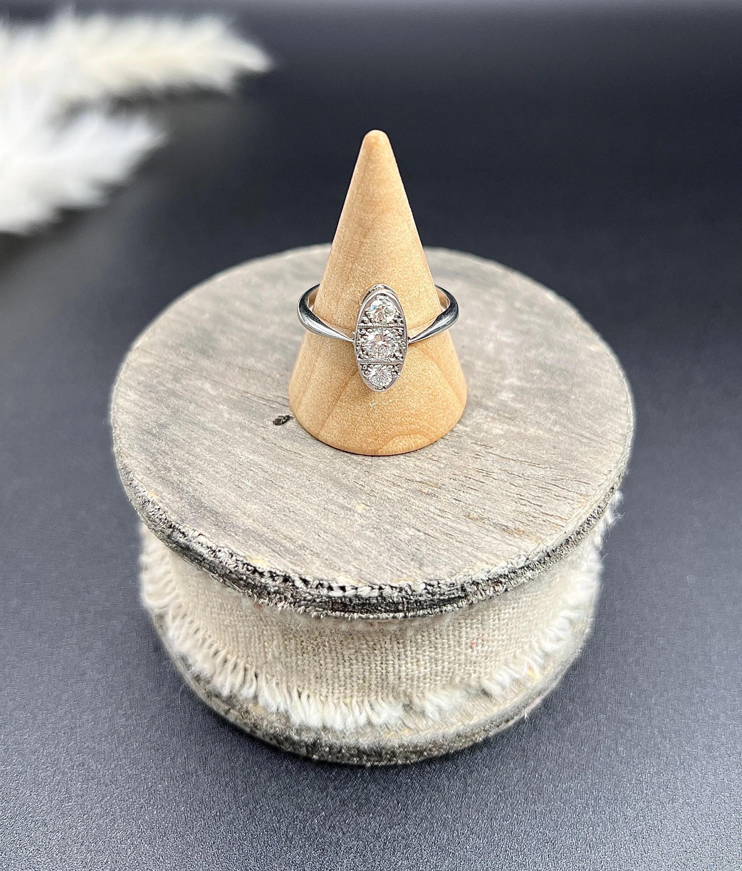 Antique Oval Diamond Ring 

Platinum Tested

Circa 1920s

Step back into the elegance of the 1920s with this exquisite Art Deco diamond ring. Showcasing a stunning design, the ring features three sparkling natural diamonds set in an oval rub-over