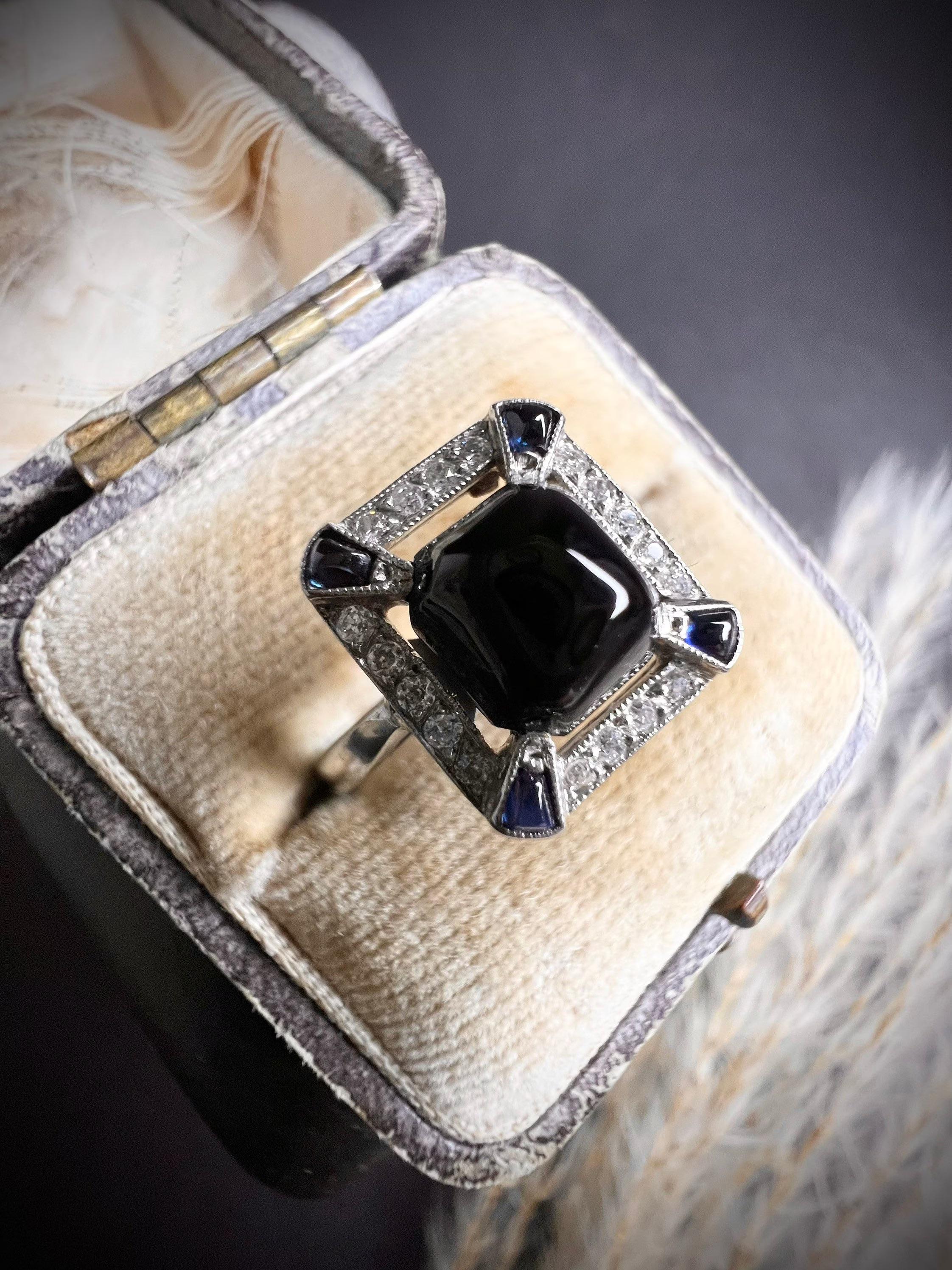 Antique Onyx Ring

Platinum Stamped 

Circa 1920’s 

Beautiful Square Shaped Antique Ring. Set with a Centre Cabochon Onyx, Cabochon Sapphire Corners & a Halo of Brilliant Cut Diamonds. 

The Ring Measures Approx Height 11.5mm & Width 10mm.

UK Size